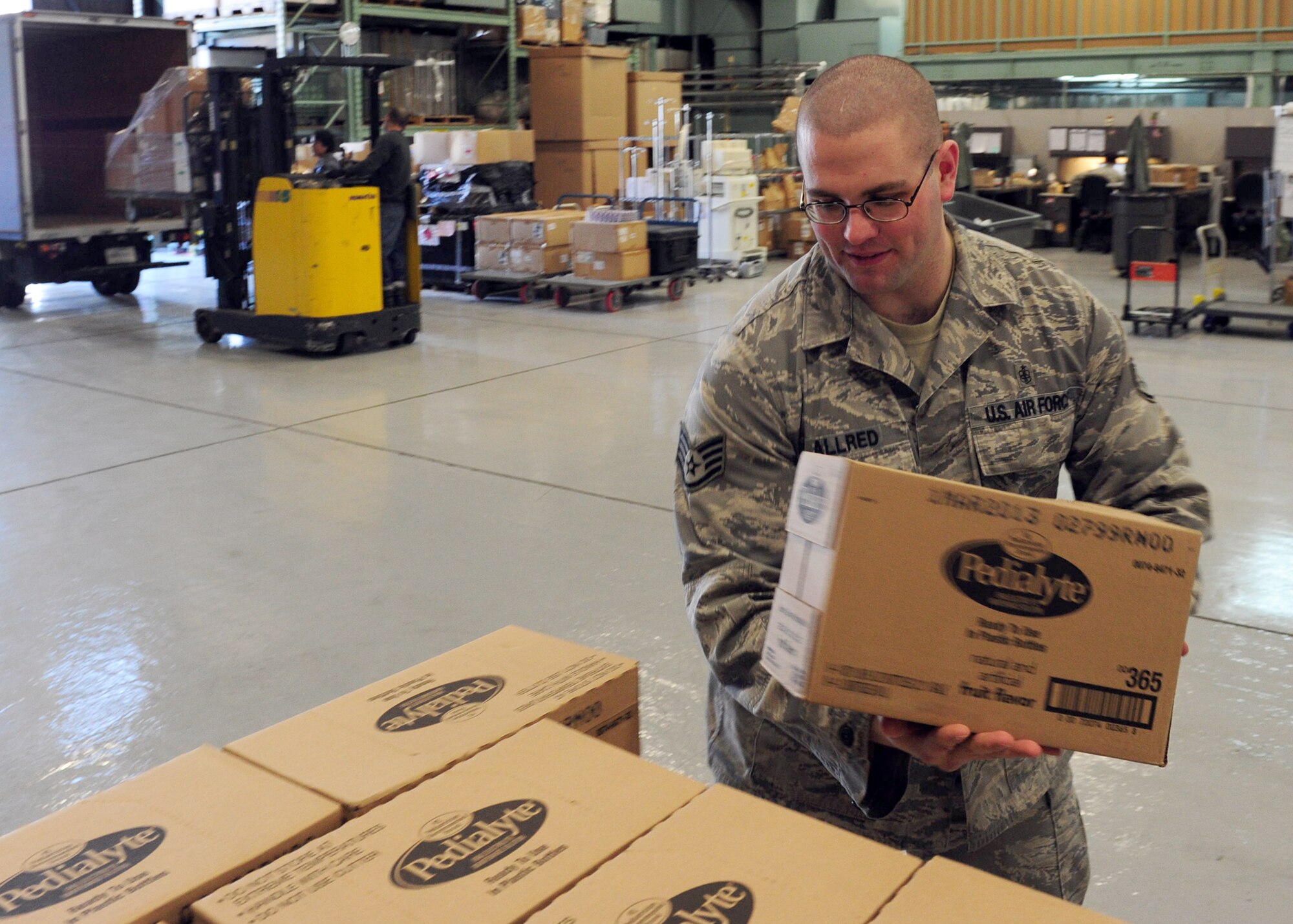 YOKOTA AIR BASE, Japan -- Staff Sgt. Brad Allder loads boxes of supplies onto a pallet at the medical logistics flight warehouse, Yokota Air Base, Japan, April 4, 2011. The 374th Medical Support Squadron at Yokota has been working diligently as the medical hub after the recent earthquake and tsunami struck Japan. Sergeant Allder is assigned to the 374th MDSS as the inventory NCO in charge. (U.S. Air Force photo/Senior Airman Michael J. Veloz)
