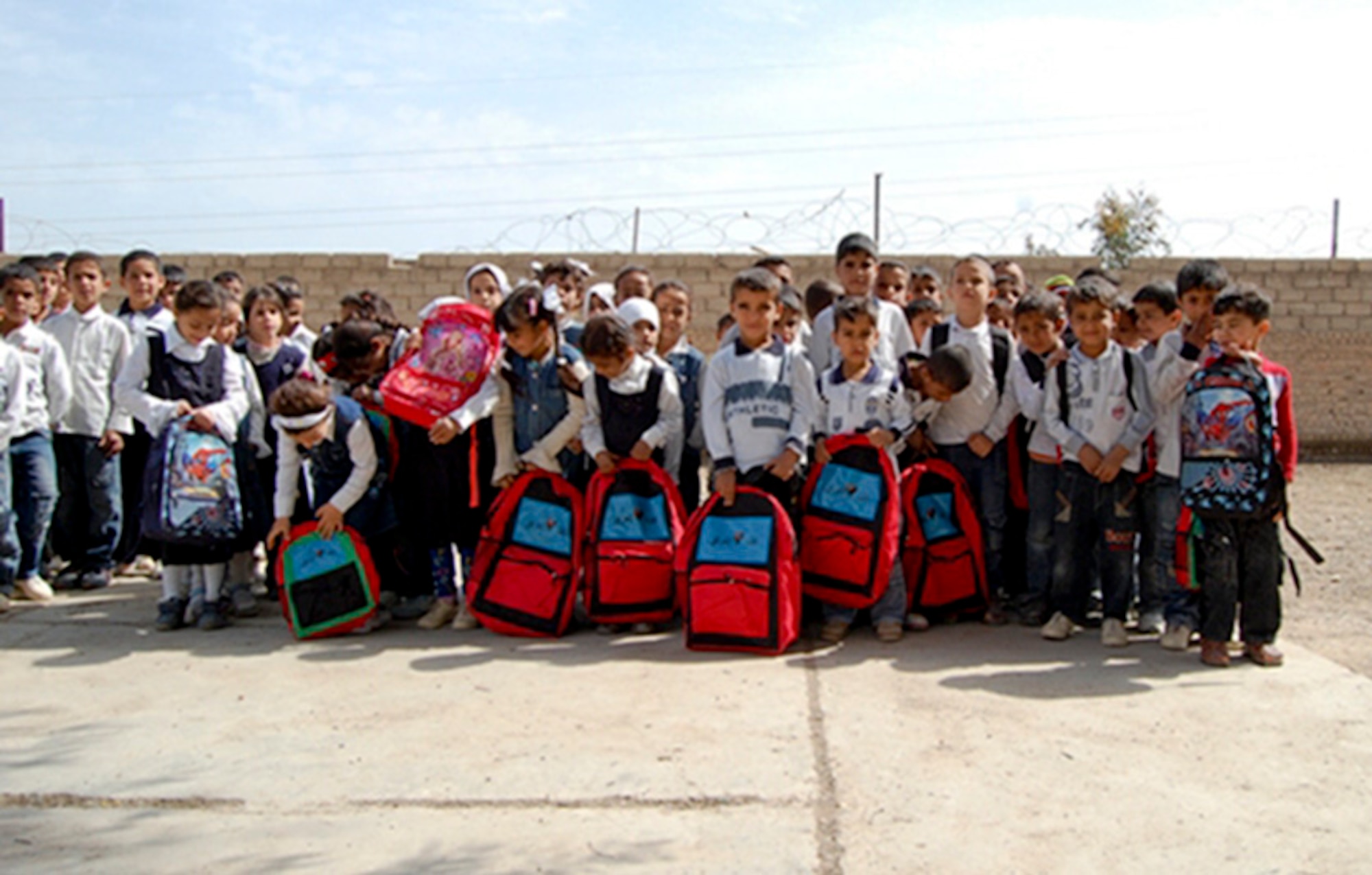 CAMP TAJI -- Iraqi school children show off the school supplies donated to their elementary school by the Iraqi military March 22. The educational materials were supplied by the 321 Mission Support and Advisory Group to help foster local community support for the Iraqi military. (Courtesy Photo)