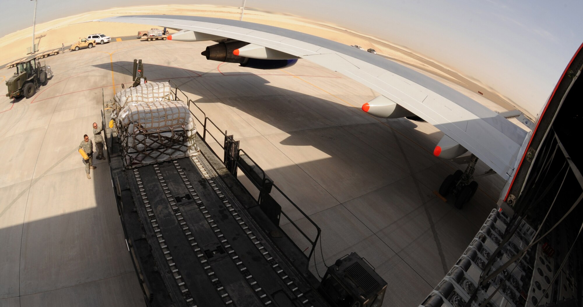 The 380th ELRS members assisted their host nation counterparts in unloading their F-16 Desert Falcon equipment used during their first deployment mission to Red Flag. This is the first time for the 380th Expeditionary Logistics Readiness Squadron's Air Terminal Operation Center to assist and train the host nation in training heavy equipment offloading. (U.S. Air Force photo by Senior Airman Maynelinne De La Cruz)