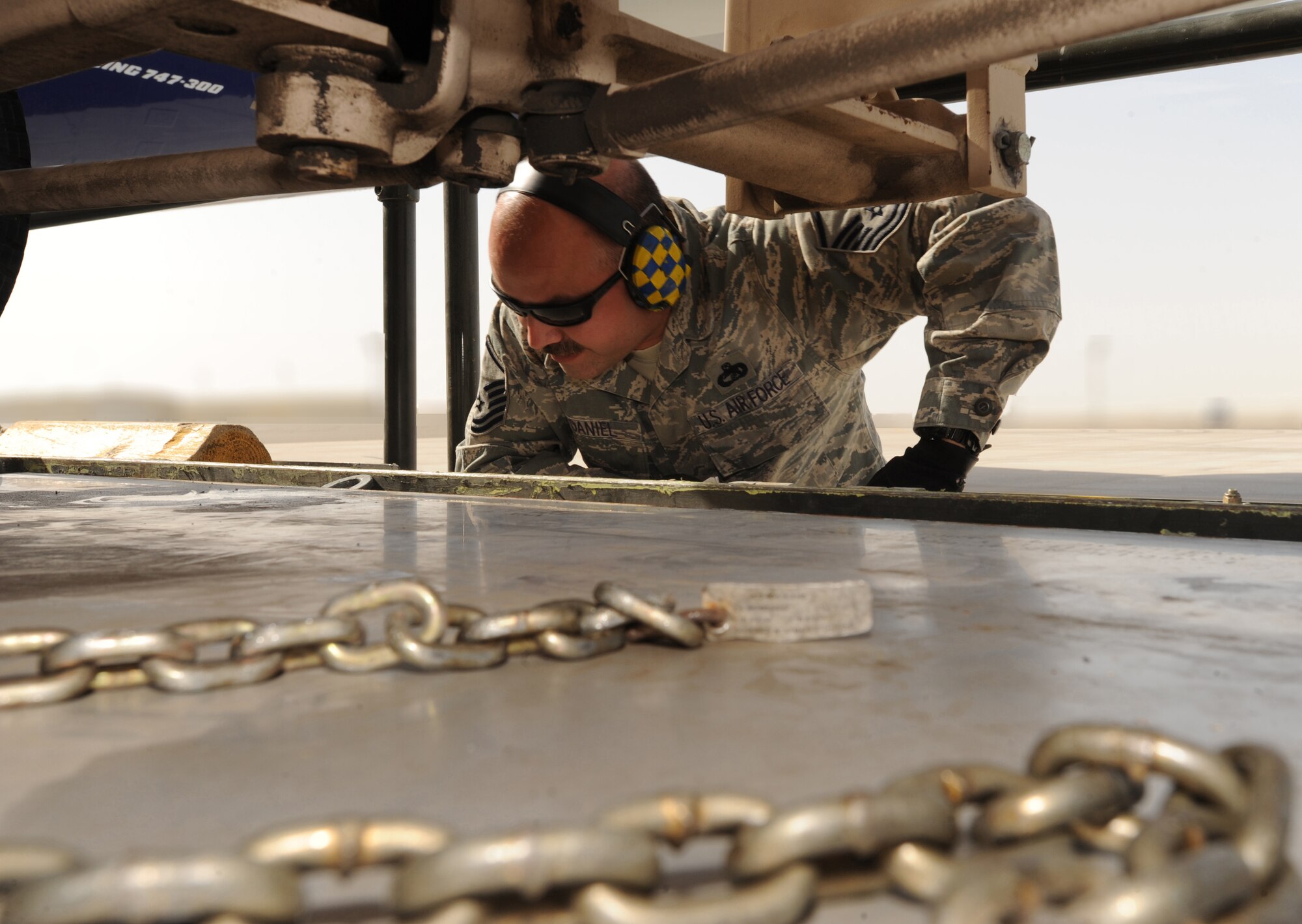 Master Sgt. Brian O'Daniel, 380th Expeditionary Logistics Readiness Squadron, insures the forklift prongs are in place before giving the signal to remove cargo from the pallet Mar. 10, 2011, in Southwest Asia. This is the first time in the Air Terminal Operations Center's history where Airmen and the host nation worked side by side assisting in heavy equipment offloading mission operations. Sergeant O'Daniel is deployed from the 89th Aerial Port Squadron, Andrews AFB, Md. (U.S. Air Force photo by Senior Airman Maynelinne De La Cruz)