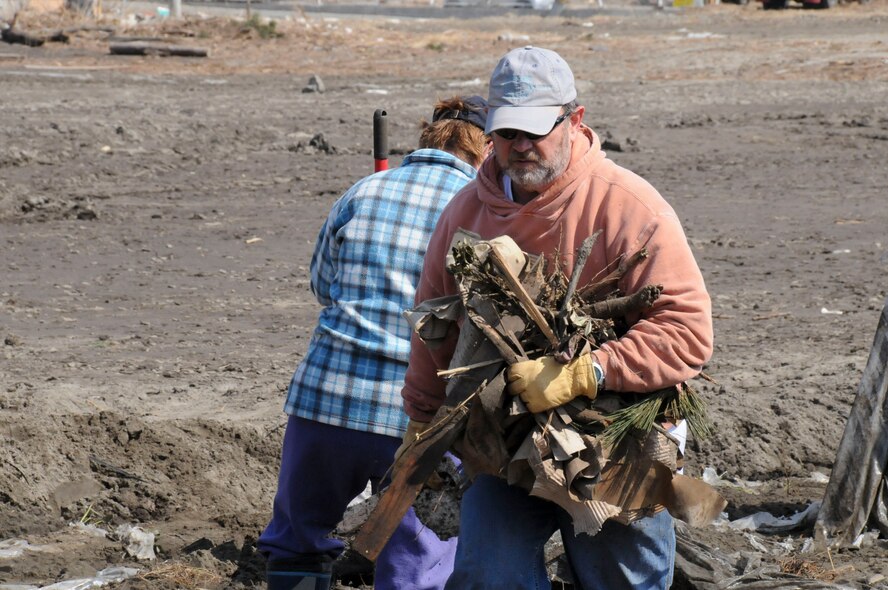 HACHINOHE, Japan -- Civilians from Misawa Air Base clear debris from a strawberry field, here April 1. The base is working with local communities to help clean up from the March 11 earthquake and tsunami that damaged the area. (U.S. Air Force photo by Staff Sgt. Rachel Martinez/Released)