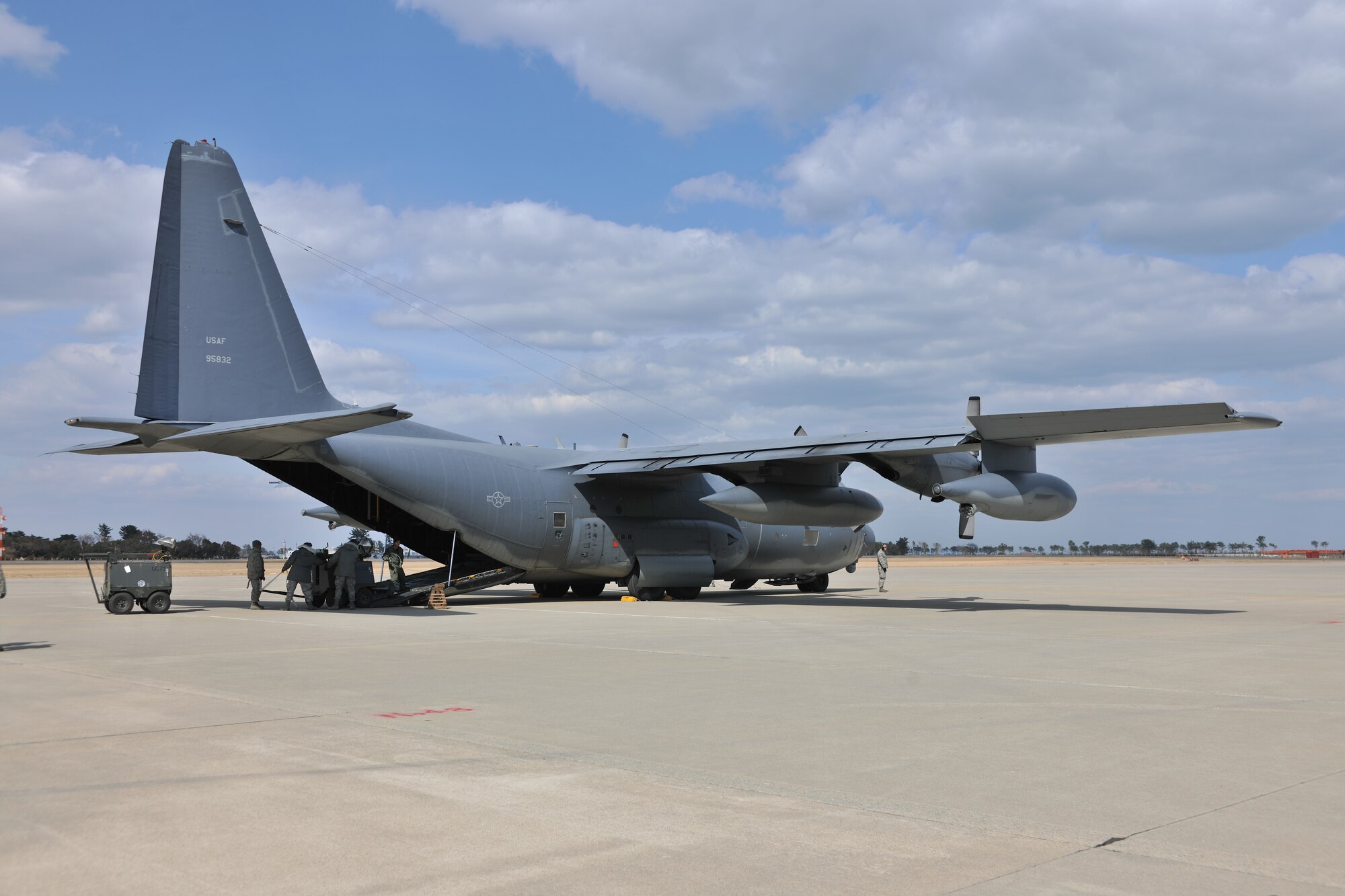 SENDAI AIRPORT, Japan -- Members from the 374th Logistics Readiness Squadron from Yokota Air Base and 17th Special Operations Squadron from Kadena Air Base work to load equipment onto an MC-130P Combat Shadow aircraft at Sendai Airport April 3. U.S. forces have assisted the Japanese with relief efforts following the earthquake and tsunami that struck March 11. (U.S. Air Force photo/Master Sgt. Kimberly Spinner) 