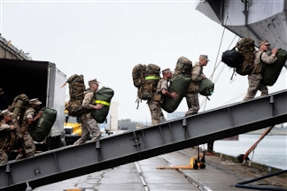 U.S. Marines embark aboard the multipurpose amphibious assault ship USS Bataan in Morehead City, N.C., on March 28, 2011.  The Bataan Amphibious Ready Group is deploying to the Mediterranean Sea.  The Marines are assigned to the 22nd Marine Expeditionary Unit.  