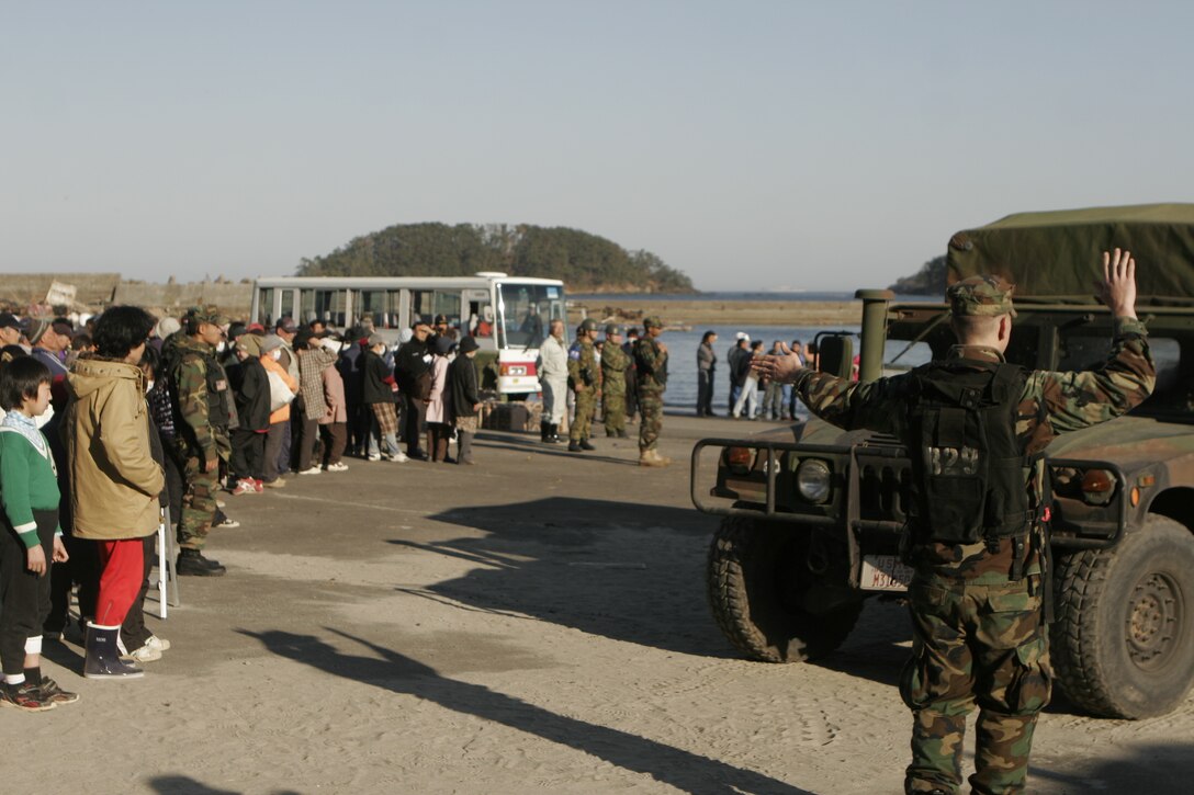 A sailor with the USS Essex (LHD 2), directs a humvee driven by a Marine with the 31st Marine Expeditionary Unit onto a U.S. Navy landing craft utility, April 6. The Marines and Sailors spent about six days cleaning up debris on parts of the island, during Operation Field Day.  The 31st MEU’s involvement is part of the larger Operation Tomodachi, coordinated after a 9.0 earthquake and subsequent tsunami struck Japan causing widespread damage. The 31st MEU remains ready to support its Japanese partners and to provide assistance when called upon.