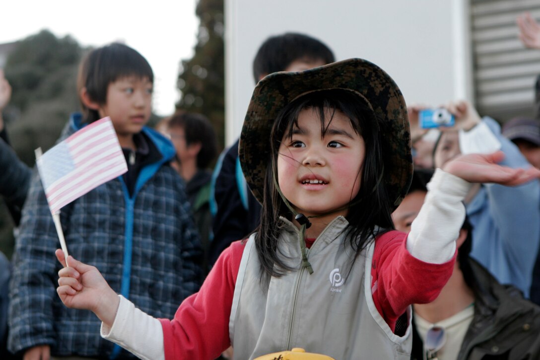 Hinano, a girl living on Oshima Island, waves goodbye to Marines of the 31st Marine Expeditionary Unit as they board a U.S. Navy landing craft utility, April 6. The Marines and Sailors spent about six days cleaning up debris on parts of the island, during Operation Field Day.  The 31st MEU’s involvement is part of the larger Operation Tomodachi, coordinated after a 9.0 earthquake and subsequent tsunami struck Japan causing widespread damage. The 31st MEU remains ready to support its Japanese partners and to provide assistance when called upon.