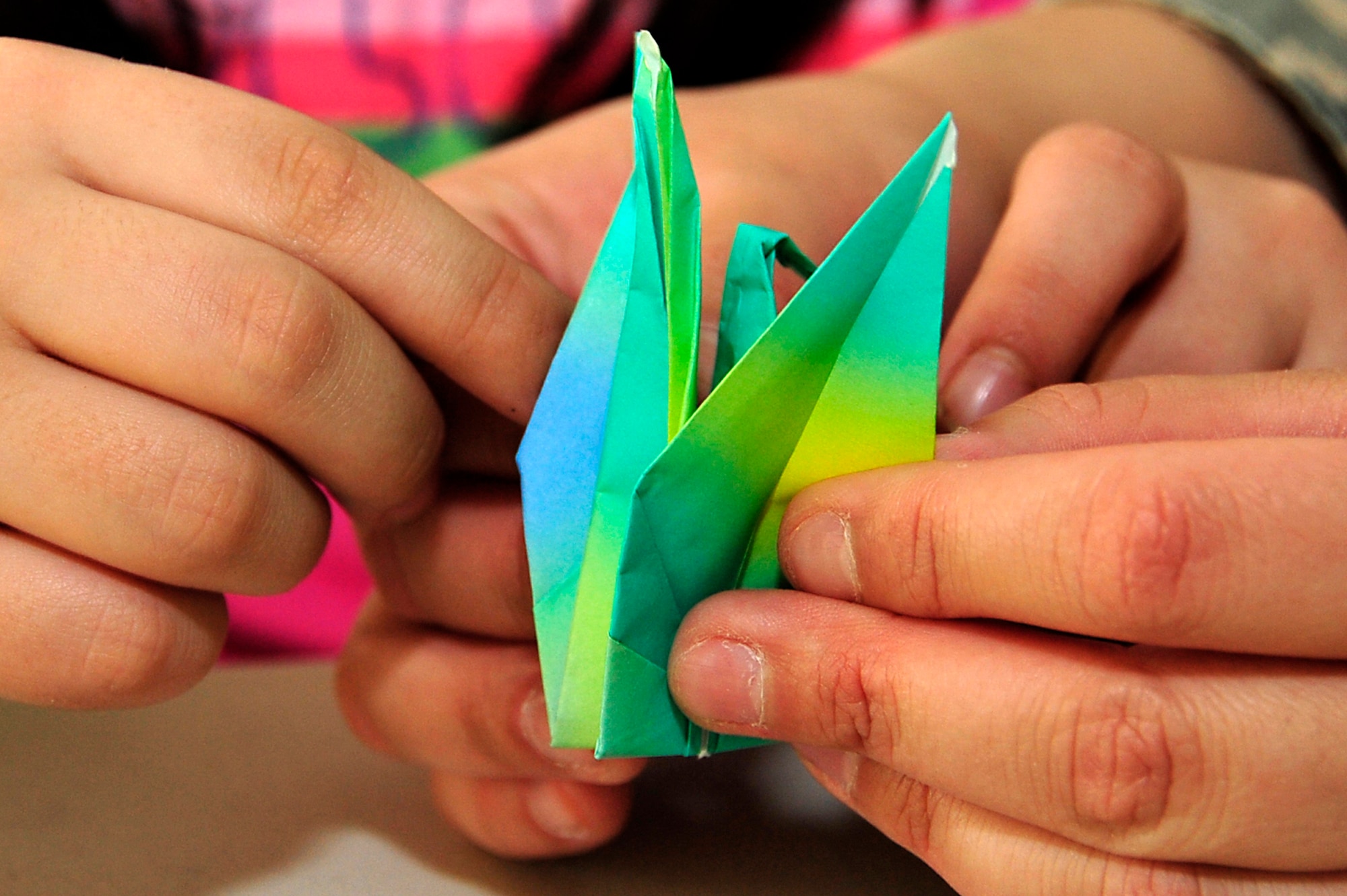 MISAWA AIR BASE, Japan -- Students and parents at Sollars Elementary School fold origami cranes April 6. Origami cranes are sacred creatures in Japanese culture. According to legend, anyone who folds a thousand paper cranes will be granted a wish by a crane. The cranes will be sent to Students Rebuild to help raise funds in support of their Japanese peers. Students Rebuild is a global organization that mobilizes young people to connect, learn and take action on critical global issues. (U.S. Air Force photo by Staff Sgt. Marie Brown\Released)