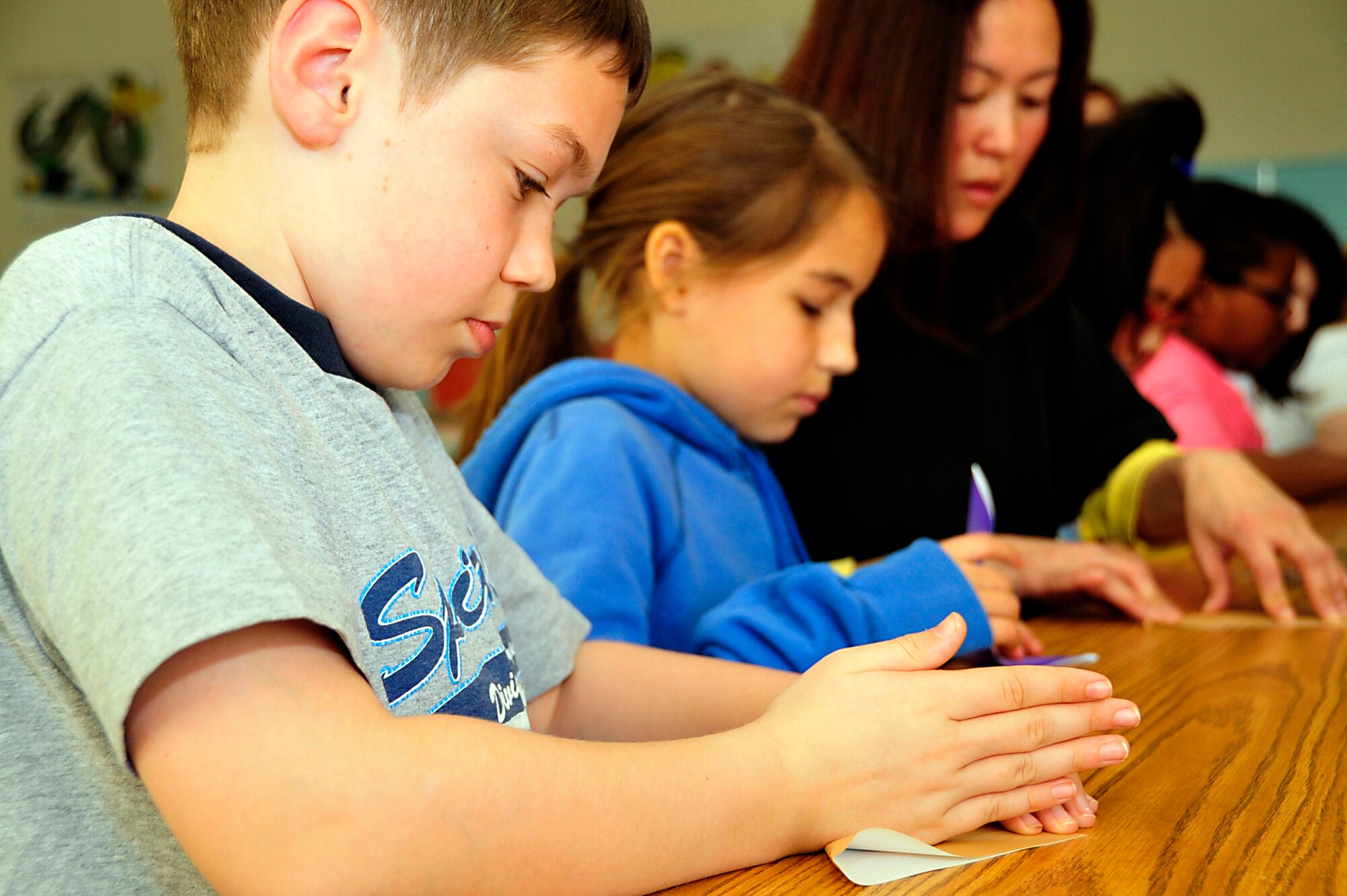 MISAWA AIR BASE, Japan -- Aidan Robinson, a fifth grade Sollars Elementary School student, folds an origami crane April 6. The school has collected more than 7,000 cranes to help reach the goal of 100,000 as part of an art display at a reconstructed school in Sendai, Japan. Students Rebuild is a global organization that mobilizes young people to connect, learn and take action on critical issues.  (U.S. Air Force photo by Staff Sgt. Marie Brown\Released)