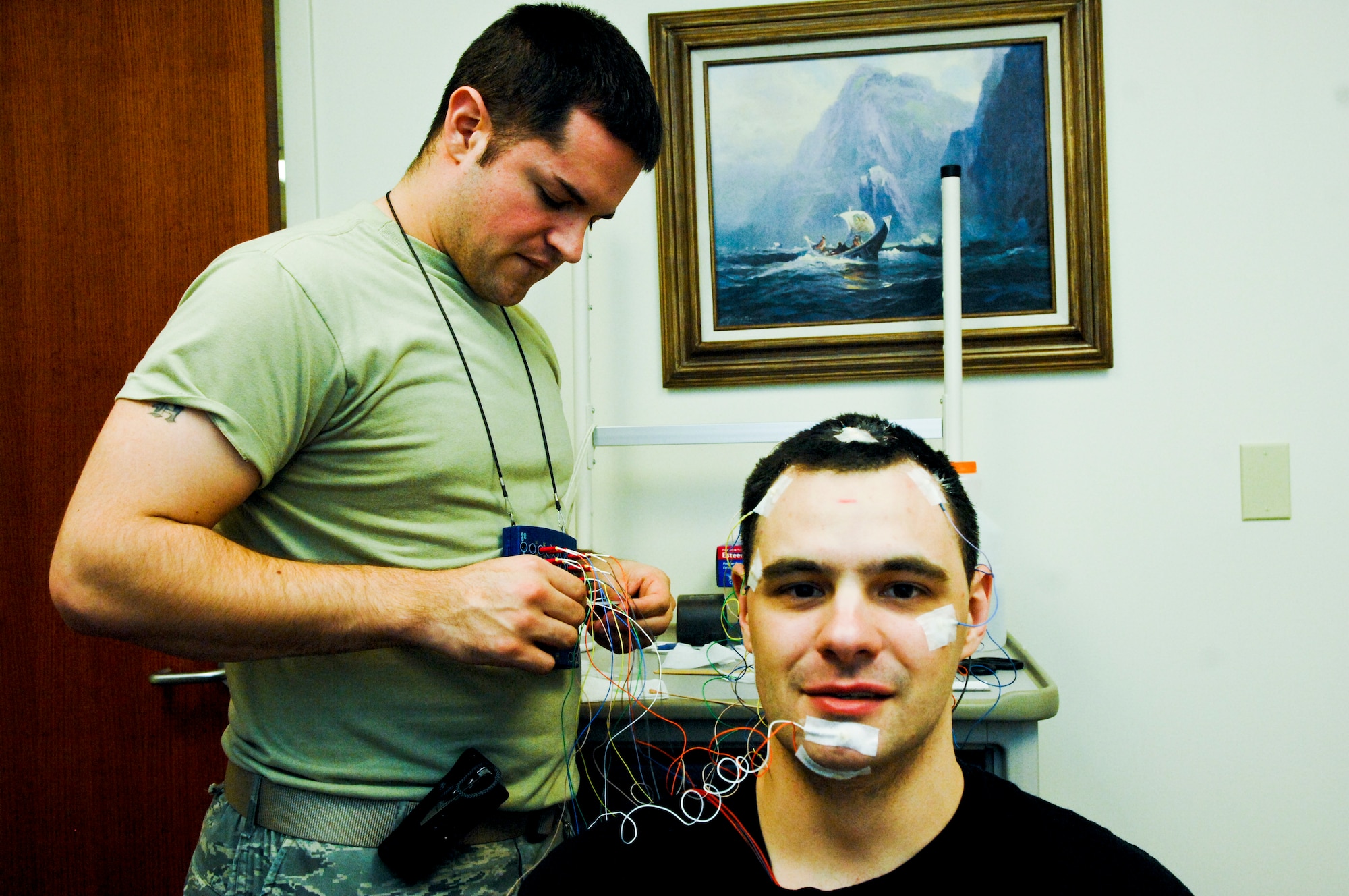 JOINT BASE ELMENDORF-RICHARDSON, Alaska - Air Force Staff Sgt. Stanley Manning, 3rd Medical Group Sleep Lab technician, applies electrodes to Jason Manzel, 725th Brigade Support Battalion, 4th Brigade Combat Team (Airborne), 25th Infantry Division, March 31. The electrodes enable the sleep lab technicians to read Manzels brain waves while he sleeps. (U.S. Air Force photo/ Airman 1st Class Jack Sanders)