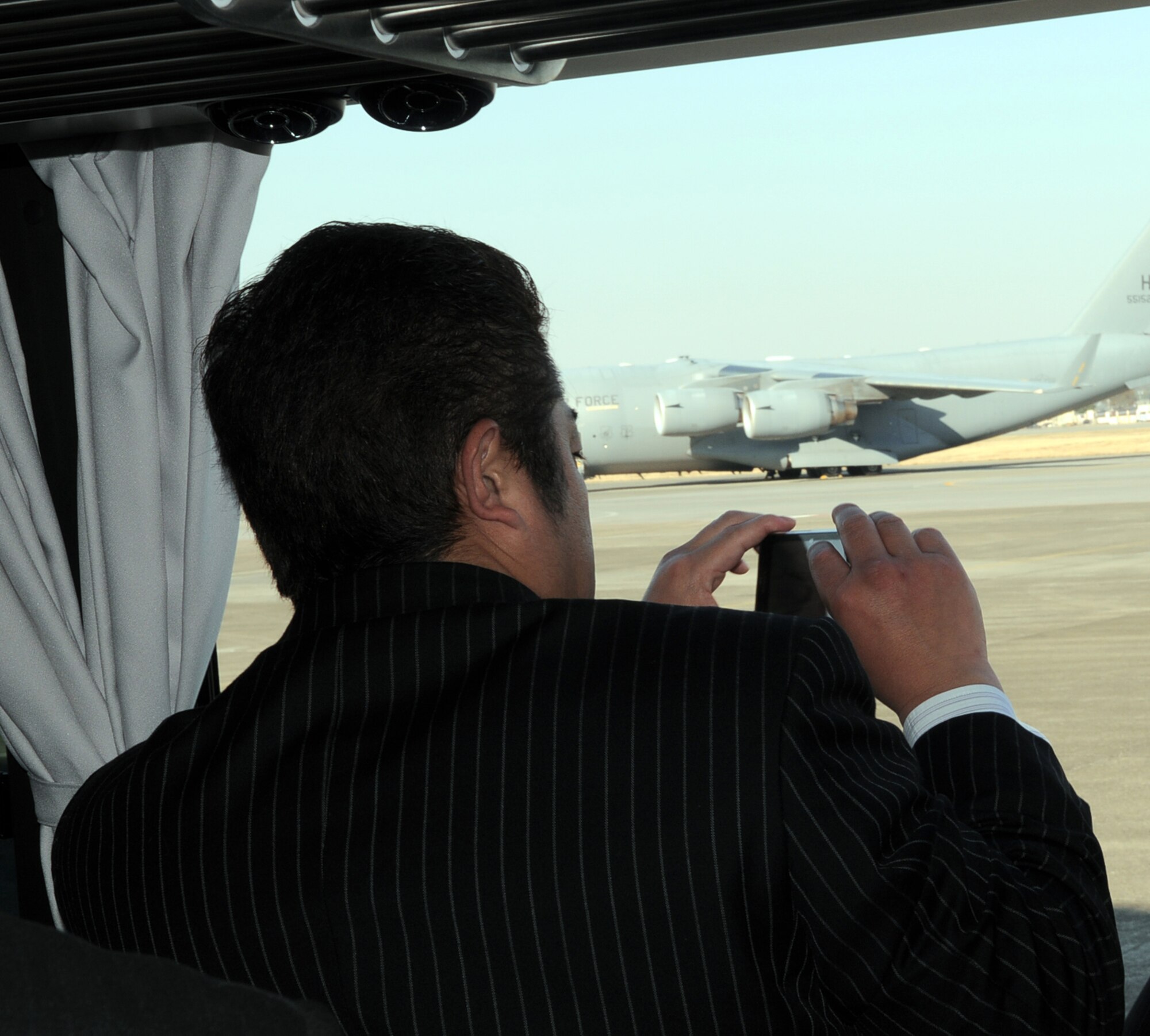 YOKOTA AIR BASE, Japan -- A member of a Yokota friendship club takes a photo of aircraft on the flightline during a base tour April 5, 2011. The friendship clubs were formed to enhance the relationship between the base and local communities as well as keep them informed of Yokota's everyday operations. (U.S. Air Force photo/Airman 1st Class Krystal M. Garrett)

