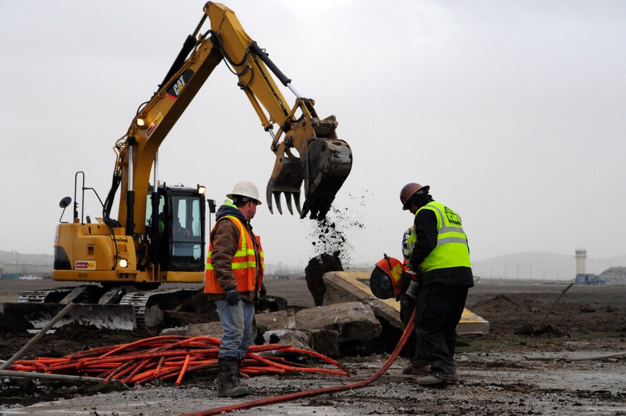 Contractors demolish the existing electrical duct banks and cut electrical conduits out on the Fairchild runway March 31. The Fairchild runway has been under construction since late February. (U.S. Air Force photo/Airman 1st Class Taylor Curry)