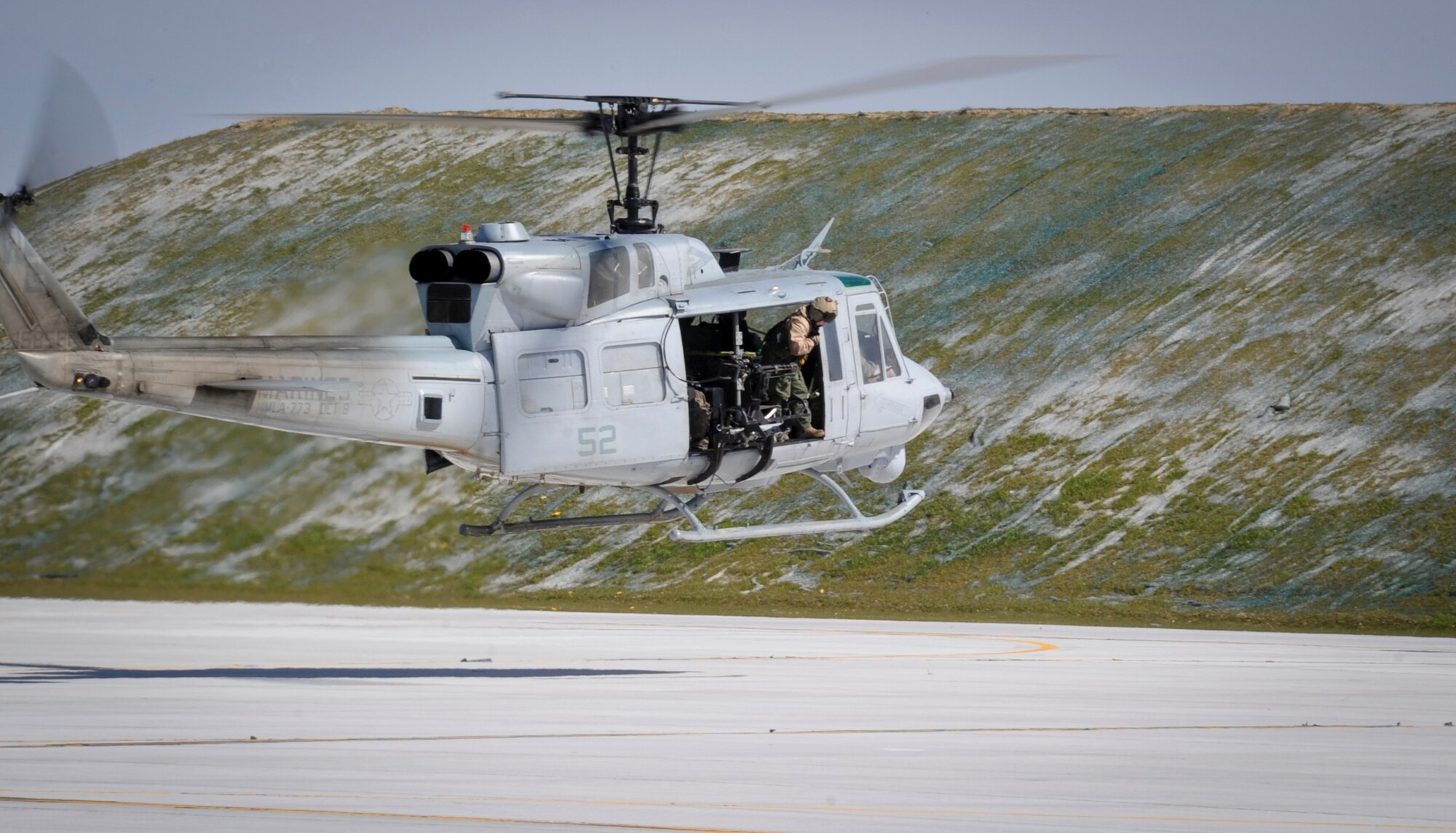 JOINT BASE MCGUIRE-DIX-LAKEHURST, N.J. -- Staff Sgt. Valerie Jelley, Marine Helicopter Light Attack Squadron 773 UH-1N crew chief, prepares for landing at Joint Base McGuire-Dix-Lakehurst March 28. HMLA-773 came from Naval Air Station Joint Reserve Base Willow Grove and is one of the newest units assigned to the installation. (U.S. Air Force photo by Airman 1st Class Bryan Swink/Released)
