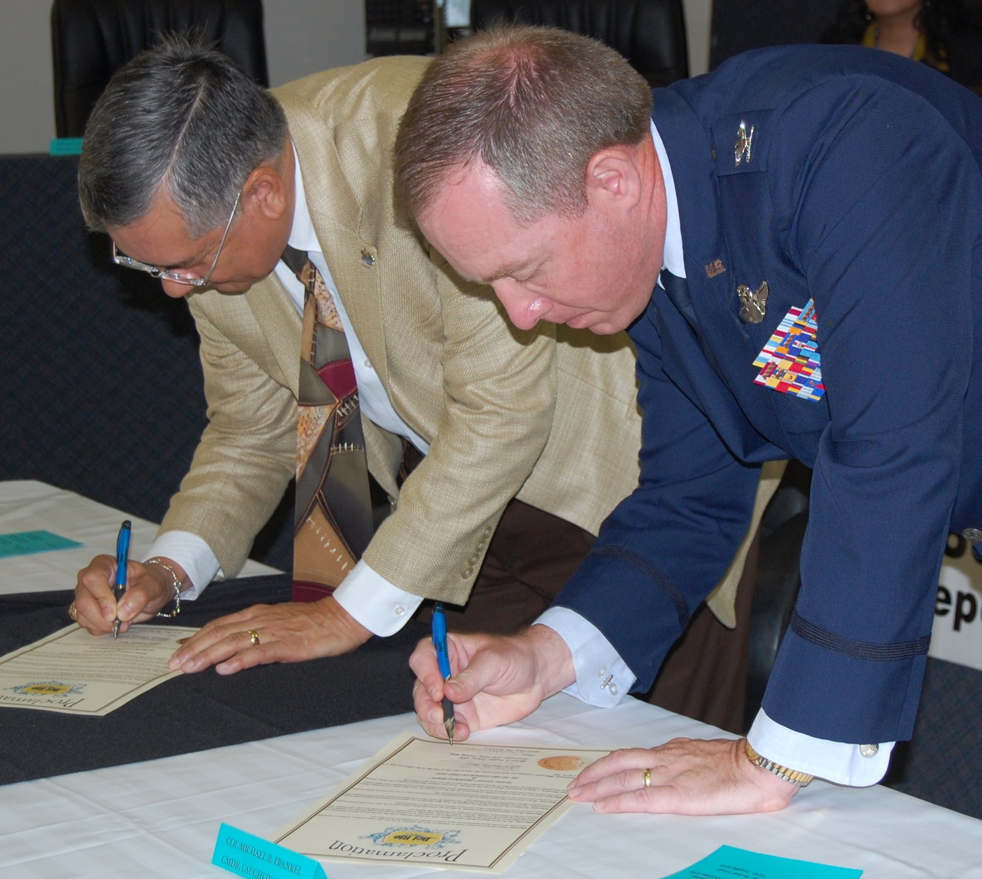 LAUGHLIN AIR FORCE BASE, Texas - - Colonel Michael Frankel, 47th Flying Training Wing commander, and Roberto Fernandez, Del Rio mayor, sign the Sexual Assault Awareness Month proclamation at Del Rio’s City Hall on April 4. (U.S. Air Force photo by 2nd Lt. Angela Martin)

