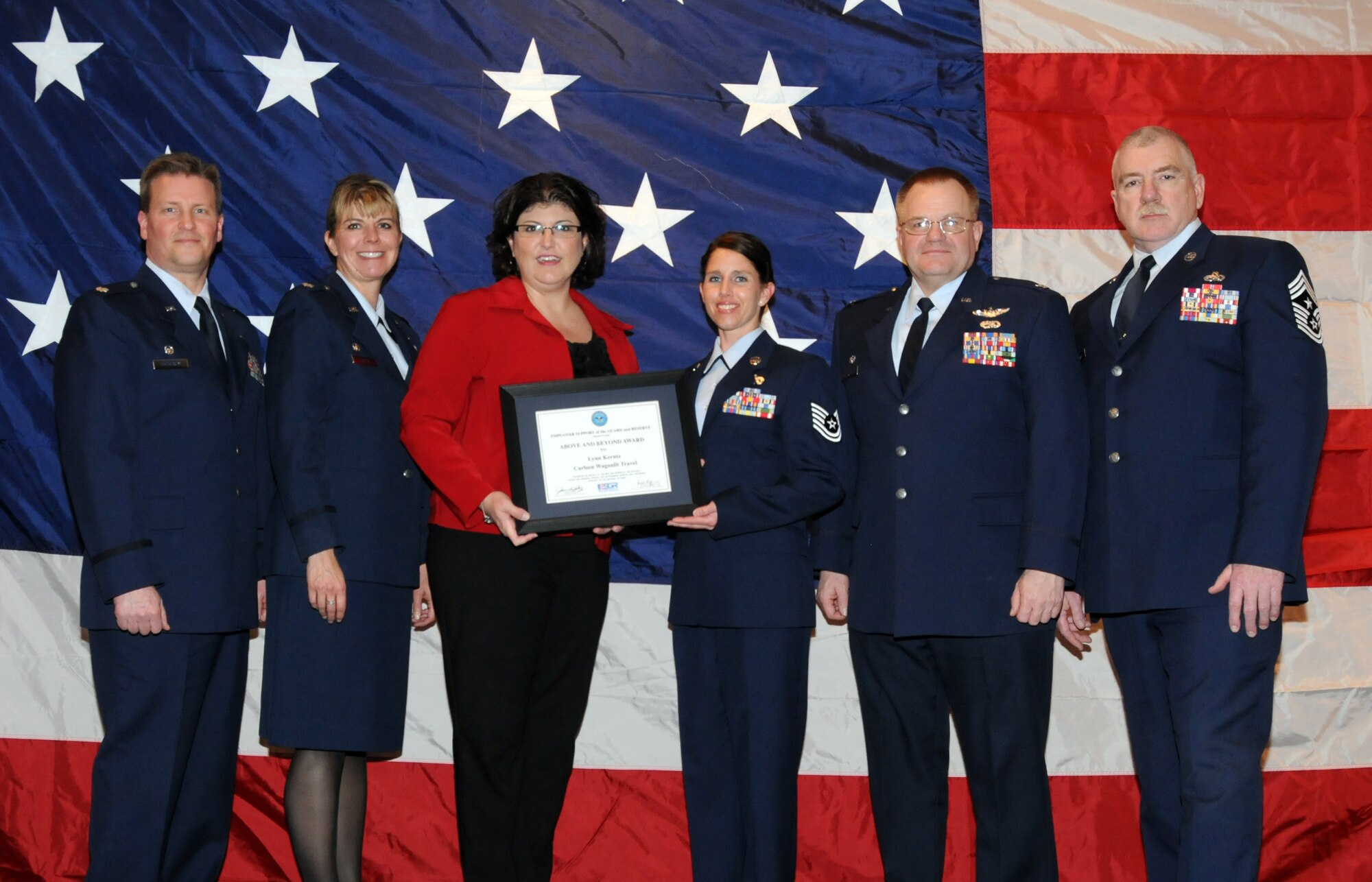 Lynn Kerntz of Carlson Wagonlit Travel poses for a group photo with members of the 148th Fighter Wing, Duluth, Minn. while attending a Minnesota Employer Support for the Guard and Reserve Banquet held in Oakdale, Minn.  Kerntz was at the banquet to accept the "Above and Beyond Award" recognizing her for supporting military employees.  (U.S. Air Force photo by Master Sgt. Ralph J. Kapustka)