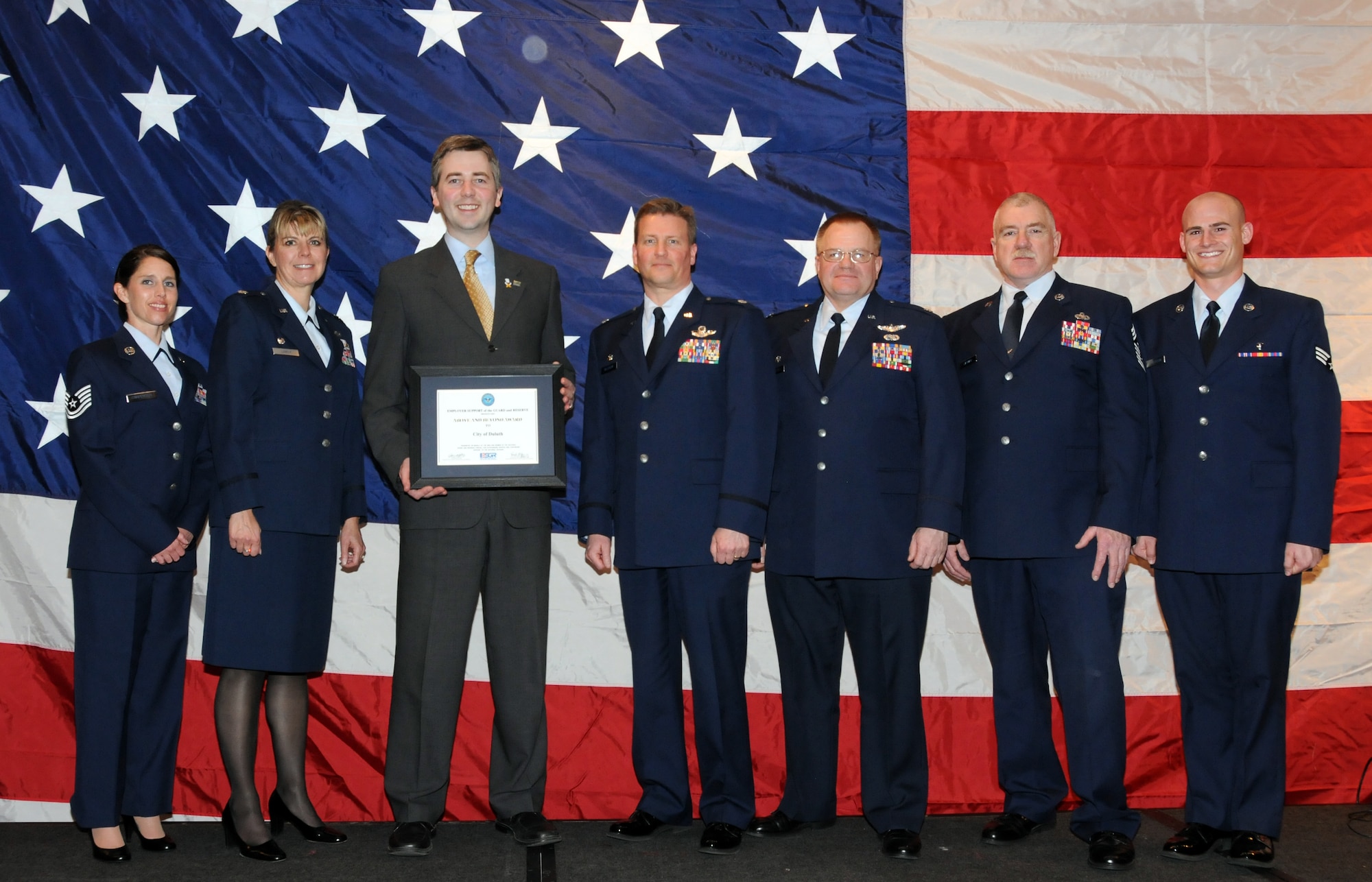 Don Ness, Mayor of Duluth, Minn. poses for a group photo with members of the 148th Fighter Wing, Duluth, Minn. while attending a Minnesota Employer Support for the Guard and Reserve Banquet held in Oakdale, Minn.  Mayor Ness was at the banquet to accept the "Above and Beyond Award" recognizing the city of Duluth for its support of military employees.  (U.S. Air Force photo by Master Sgt. Ralph J. Kapustka)