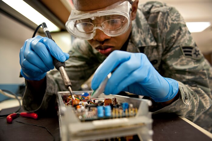 NELLIS AIR FORCE BASE, Nev. -- Senior Airman Mathew Harrington, a Precision Measurement Equipment Laboratory journeyman assigned to the 57th Maintenance Squadron, conducts maintenance on a 53 plug-in unit, which is used to calibrate an oscilloscope April 5. An oscilloscope is a electronic instrument used for measuring electronic sound waves. (U.S. Air Force photo by Senior Airman Michael Charles)