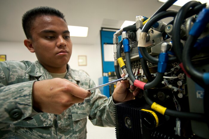 NELLIS AIR FORCE BASE, Nev. -- Senior Airman Alfred Trinidad, a Precision Measurement Equipment Laboratory journeyman assigned to the 57th Maintenance Squadron, conducts maintenance on a TTU-205 pressure temperature test set April 5. A TTU-205 test set checks aircraft panels inside the cockpit for accuracy and functionality. (U.S. Air Force photo by Senior Airman Michael Charles)