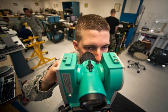 NELLIS AIR FORCE BASE, Nev. -- Senior Airman Brian Thompson, a Precision Measurement Equipment Laboratory journeyman assigned to the 57th Maintenance Squadron, calibrates a theodolite for the 99th Civil Engineers Squadron April 5. A theodolite is used for surveying land and tracking weather balloons. (U.S. Air Force photo by Senior Airman Michael Charles)