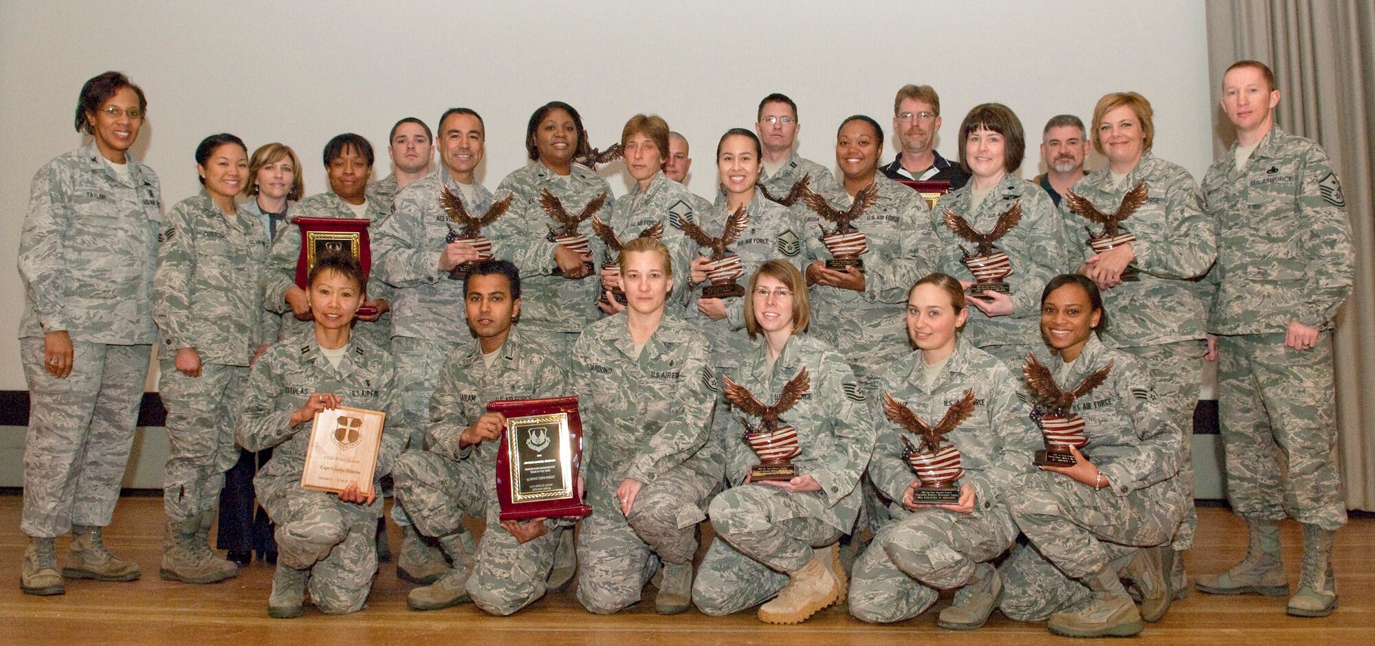 Award winning Airmen from the 95th Medical Group pose together in the Base Theater April 4 following an award ceremony. The 95th MDG had 22 Air Force Materiel Command level winners. They will next compete at Air Force level. (Air Force photo by Michael Yncera)