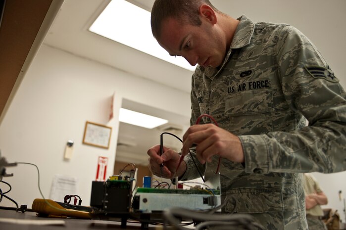 NELLIS AIR FORCE BASE, Nev. -- Senior Airman Jeffrey Frenz, a Precision Measurement Equipment Laboratory journeyman assigned to the 57th Maintenance Squadron, troubleshoots a thermal couple calibrator for an F-15 Eagle April 5. PMEL Airmen calibrate support equipment for aircraft in the Air Force inventory.(U.S. Air Force photo by Senior Airman Michael Charles)