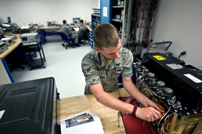NELLIS AIR FORCE BASE, Nev.-- Airman 1st Class Joseph Harris, a Precision Measurement Equipment Laboratory apprentice assigned to the 57th Maintenance Squadron, takes apart a joint service electronic combat systems tester(JSECST) April 5. A JSECST  provides an end-to-end functional testing capability to determine the status of electronic systems installed in or on operational aircraft. (U.S. Air Force photo by Airman 1st Class Matthew Lancaster)