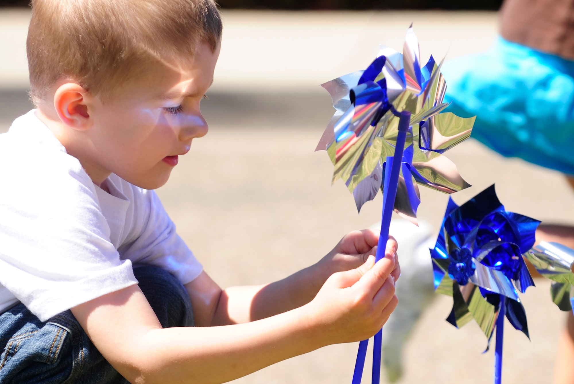 VANDENBERG AIR FORCE BASE, Calif. -- A child checks a pinwheel in front of the Child Development Center here Monday, April 4, 2011.  The pinwheel displays brought the Vandenberg community together in recognition of Child Abuse Awareness Month.  (U.S. Air Force photo/Staff Sgt. Andrew Satran)
  