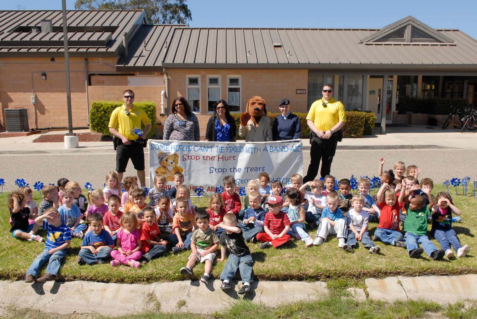 VANDENBERG AIR FORCE BASE, Calif. -- Members of Family Advocacy, 30th Security Forces Squadron,  McGruff and the children of Vandenberg pose for a photo in front of the Child Development Center here Monday, April 4, 2011.  The pinwheels are symbolic of Child Abuse Awareness Month.  (U.S. Air Force photo/Staff Sgt. Andrew Satran)

 