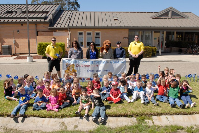VANDENBERG AIR FORCE BASE, Calif. -- Members of Family Advocacy, 30th Security Forces Squadron,  McGruff and the children of Vandenberg pose for a photo in front of the Child Development Center here Monday, April 4, 2011.  The pinwheels are symbolic of Child Abuse Awareness Month.  (U.S. Air Force photo/Staff Sgt. Andrew Satran)

 