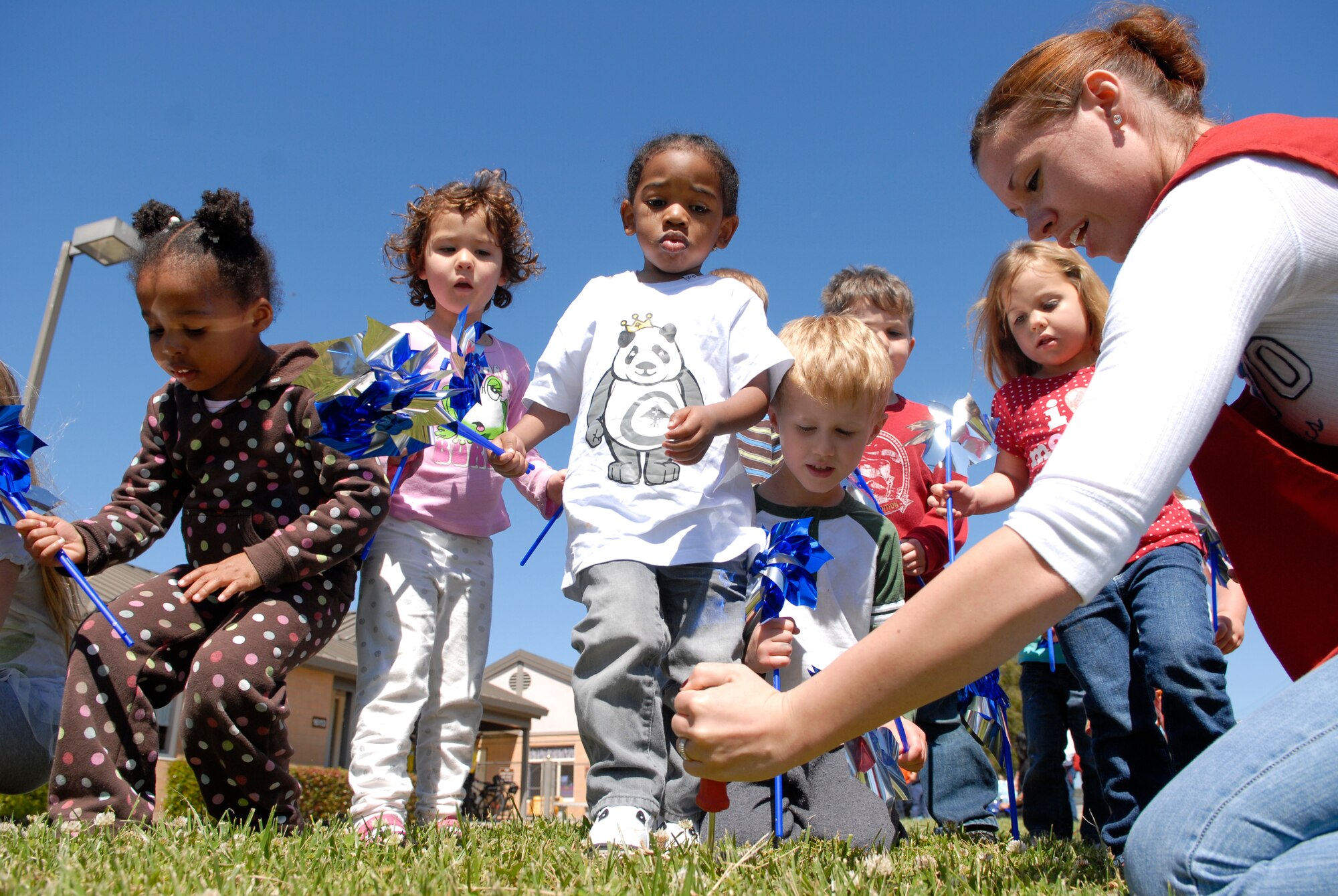 VANDENBERG AIR FORCE BASE, Calif. -- Children place pinwheels in front of the Child Development Center here Monday, April 4, 2011.  The pinwheel displays brought the Vandenberg community together in recognition of Child Abuse Awareness Month.  (U.S. Air Force photo/Staff Sgt. Andrew Satran)


 