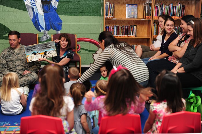 NELLIS AIR FORCE BASE, Nev. --   Col. Steven Garland, 99th Air Base Wing commander, and his wife Paula Garland read books to military family members at the base library to support National Child Abuse Prevention Month, April 6, 2011. National Child Abuse Prevention Month is a proclamation announced each April by the President of the United States to encourage public awareness of child abuse and neglect, recommit State resources to the cause and promote community involvement through State and local activities.   (U.S. Air Force photo by Staff Sgt. William P.Coleman)  