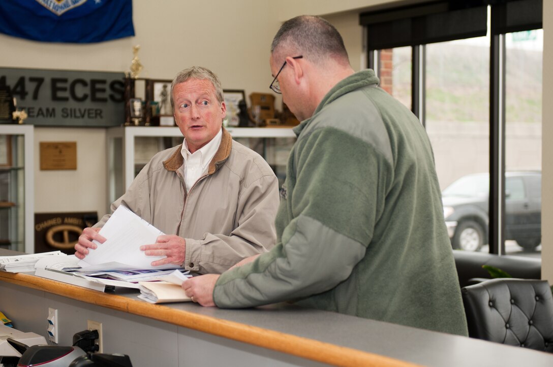 Jim Rawe, an environmental assessor from the National Guard Bureau, reviews office records March 29, 2011, with Tech. Sgt. Ron Shears, a production control specialist for the 123rd Civil Engineer Squadron, during the ESOHCAMP audit at the Kentucky Air National Guard Base in Louisville, Ky. The inspection examined programs in safety, environmental management and occupational health. (U.S. Air Force photo by Master Sgt. Philip Speck)