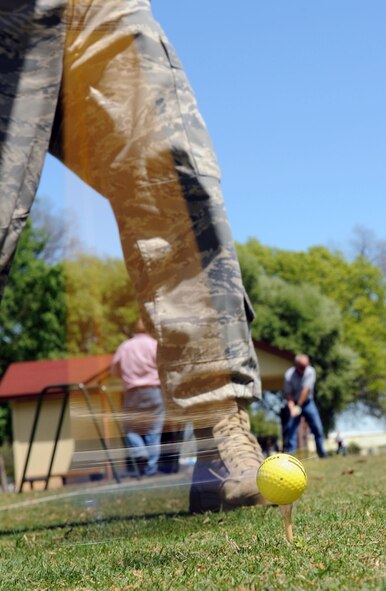 Airman 1st Class Nick Kaddatz, 2nd Operations Support Squadron, power drives the golf ball on the driving range of the Fox Run Golf Course at Barksdale Air Force Base, La., April 6, during his lunch break. He is getting back in the swing of golf after one year off. (U.S. Air Force photo/Senior Airman Alexandra M. Boutte) (RELEASED)