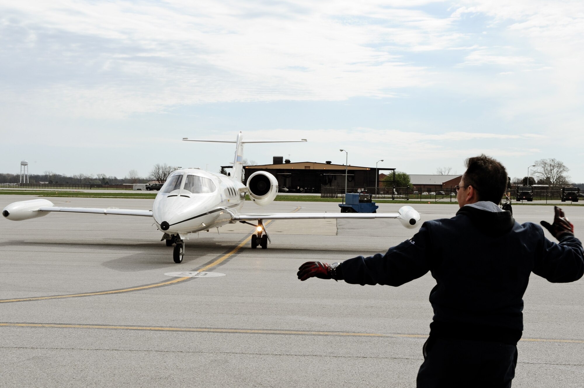 Steve Edwards, DynCorp International contractor, marshals out a C-21A for take-off April 6, 2011 at Scott Air Force Base, Ill. The C-21 was flown during the initial qualification course under the 458th AS after it regained the C-21 training mission from the 45th AS at Kessler AFB, Miss. The C-21 training mission belonged to Scott until the early 1990s. (U.S. Air Force Photo/Staff Sgt. Brian J. Valencia)