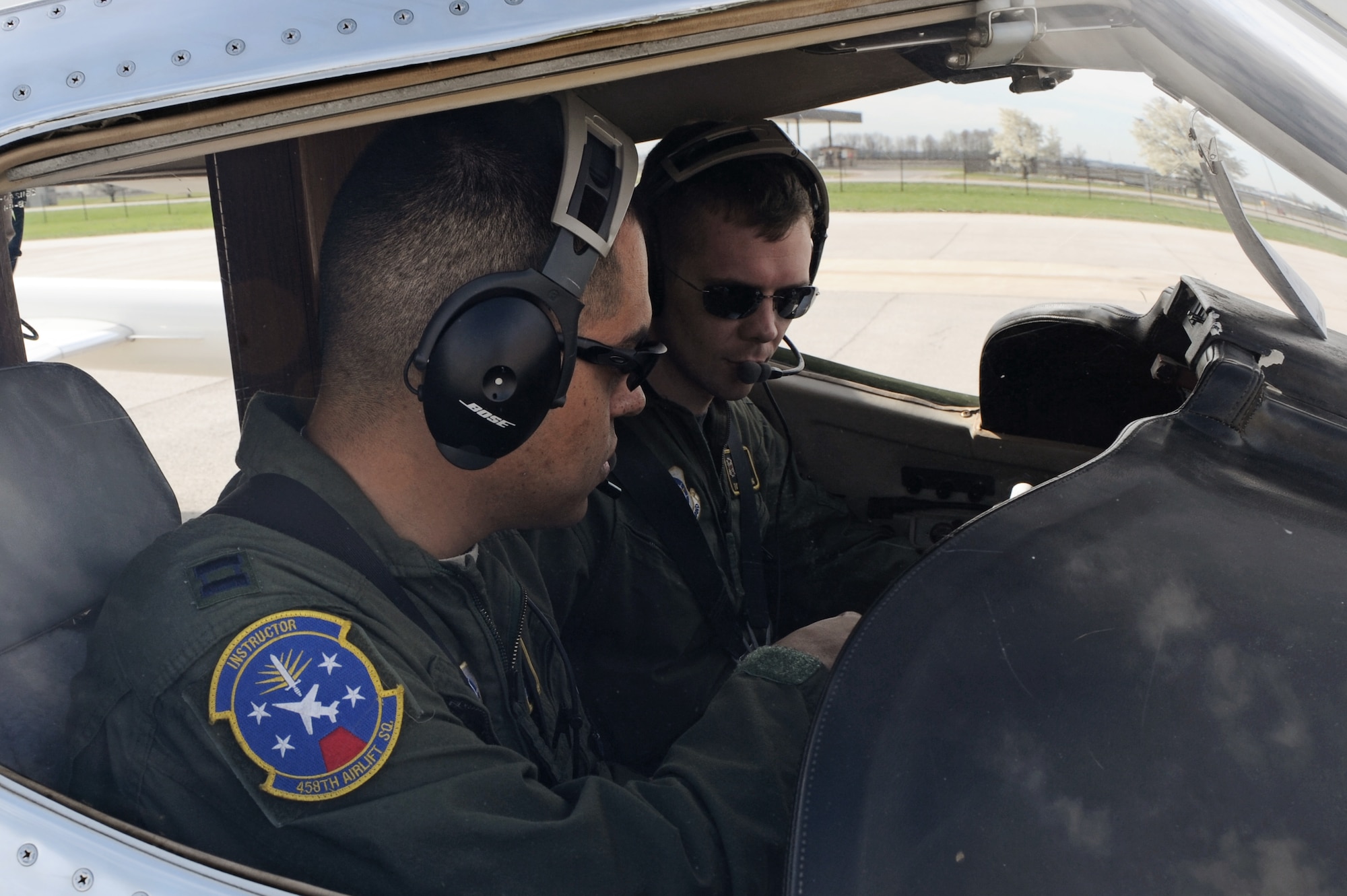 Capt. Luis Garces and Capt. Thomas Armstrong, both with the 458th Airlift Squadron's C-21A formal training unit, perform pre-flight checks prior to take-off April 6, 2011 at Scott Air Force Base, Ill. Captain Garces is training Captain Armstrong during the initial qualification course under the 458th AS after it regained the C-21 training mission from the 45th AS at Kessler AFB, Miss. The C-21 training mission belonged to Scott until the early 1990s. (U.S. Air Force Photo/Staff Sgt. Brian J. Valencia)