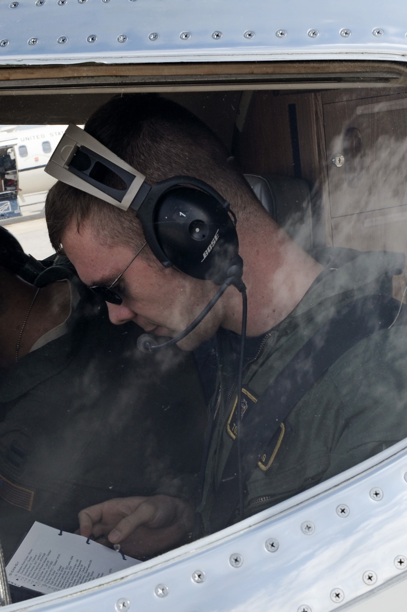 Capt. Thomas Armstrong, a student with the 458th Airlift Squadron's C-21A formal training unit, checks his pre-flight checklist prior to take-off April 6, 2011 at Scott Air Force Base, Ill. Captain Armstrong was part of the initial qualification course under the 458th AS after it regained the C-21 training mission from the 45th AS at Kessler AFB, Miss. Upon completion of his training, Captain Armstrong will fly out of Ramstein Air Base, Germany. (U.S. Air Force Photo/Staff Sgt. Brian J. Valencia)