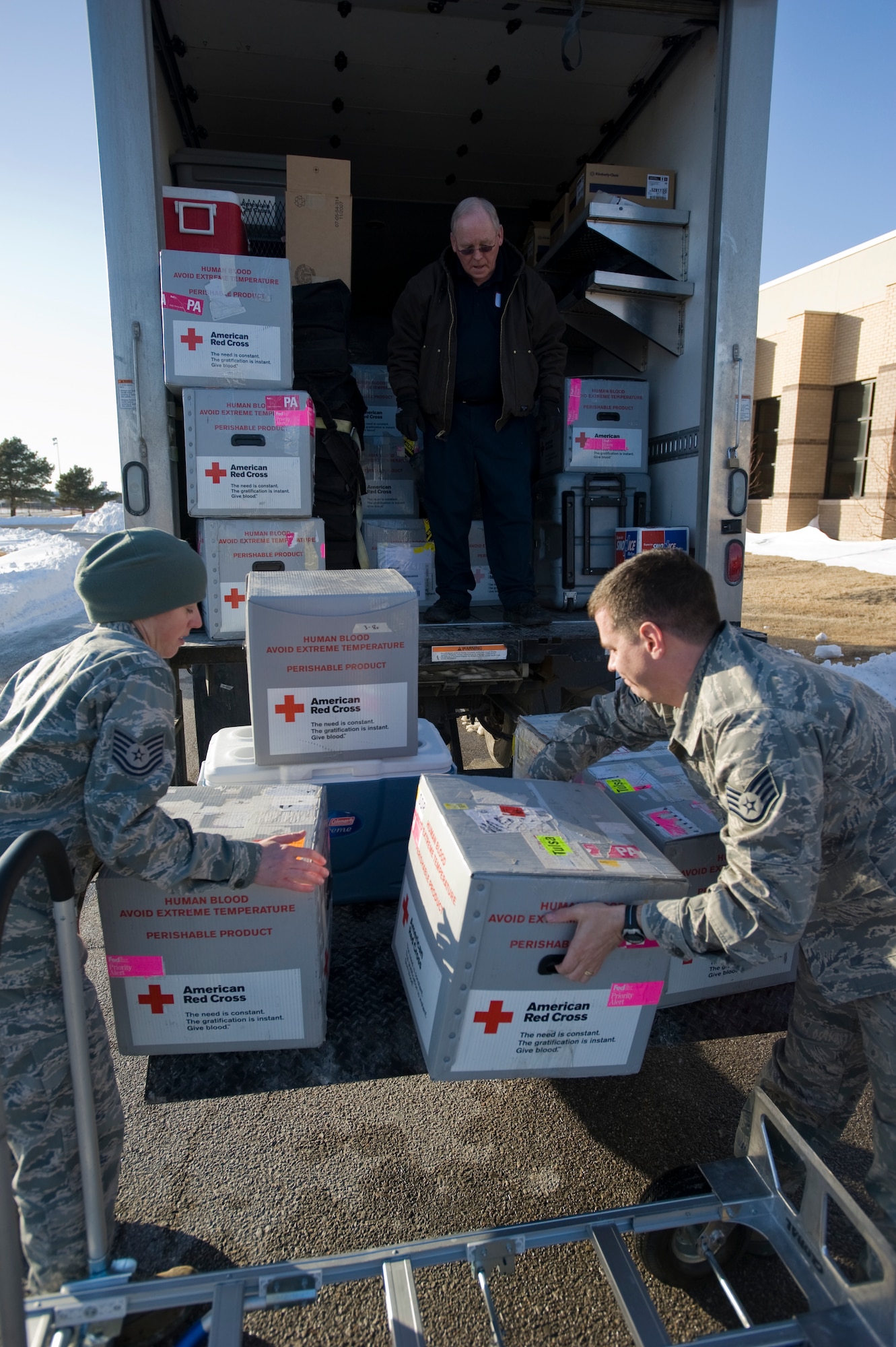 Two Team McConnell members load donated blood onto an American Red Cross truck Feb. 4, 2011, McConnell Air Force Base, Kan. During a national blood shortage caused by extreme weather, McConnell’s Airmen donated 130 pints of blood. (U.S. Air Force photo/Airman 1st Class Armando A. Schwier-Morales)  
