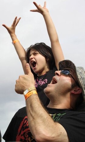 NELLIS AIR FORCE BASE, Nev. – Bethany Millican, 9, and her father Lt. Col. Tony Millican, 98th Mission Support Group deputy commander, cheer on Montgomery Gentry during the USO and Academy of Country Music Award concert held April 2 at the Nellis Sports Pavilion.  This year’s concert featured Brett Eldredge, Blake Shelton, Luke Bryan, Sunny Sweeney, Little Big Town, Craig Morgan, Miss Willie Brown and Montgomery Gentry.