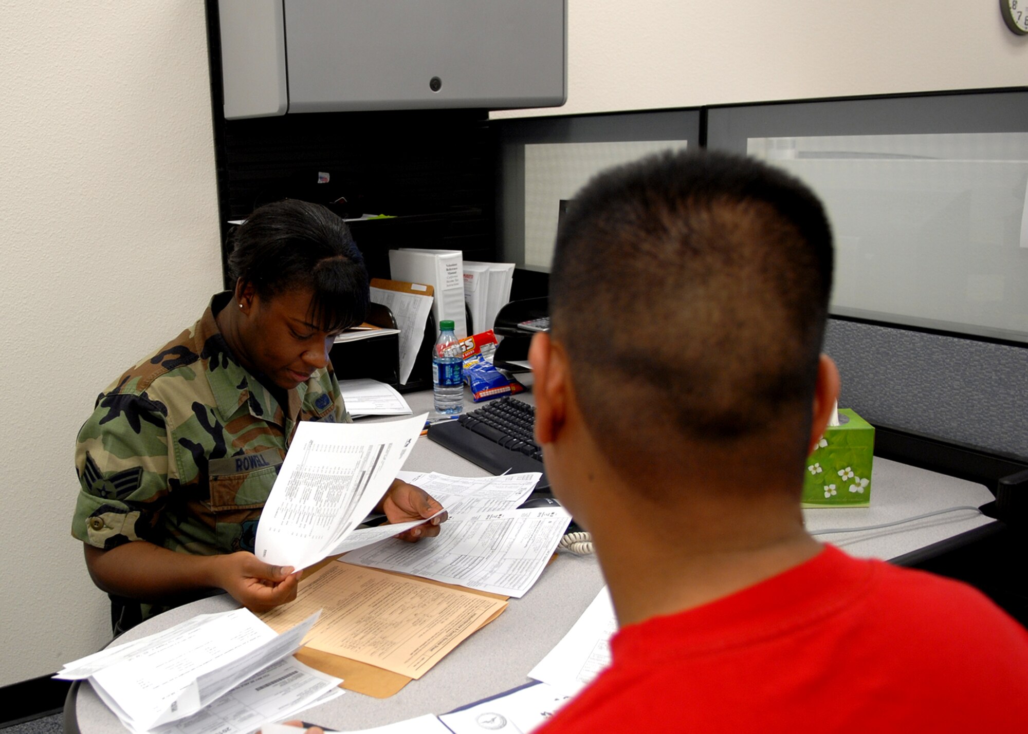 Senior Airman Mel‘Anie Rowell, Air Force Flight Test Center Judge Advocate Office paralegal, helps Senior Airman Apolinario Domingo file his federal tax return. Airman Domingo is a medical technician in the 95th Medical Operations Squadron. Appointments can be scheduled at the Edwards Tax Center Monday to Thursday from 9 a.m. to 3 p.m., while walk-ins are welcome Fridays from 9 a.m. to 1 p.m. (Air Force photo by Kate Blais)