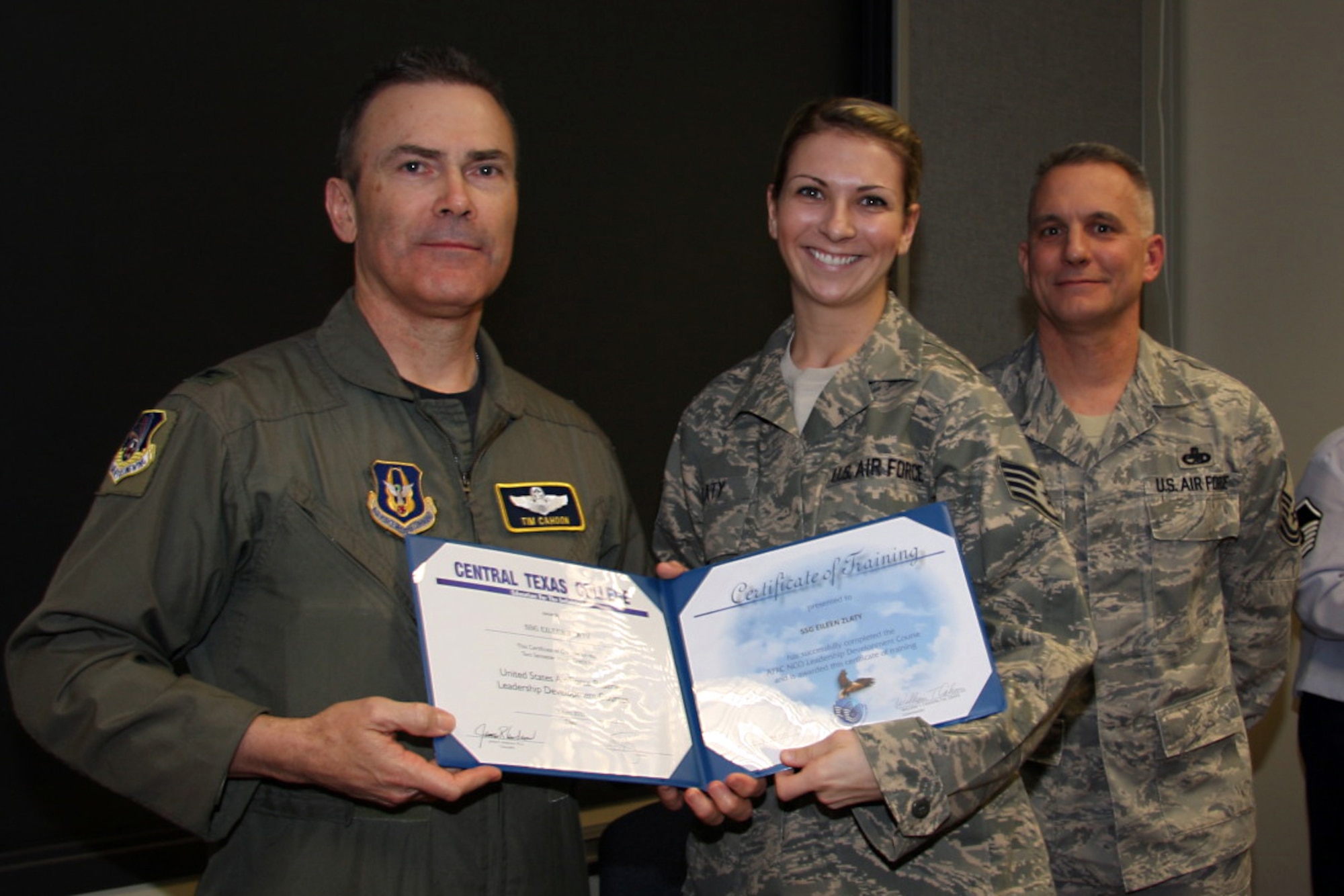 GRISSOM AIR RESERVE BASE, Ind. -- Staff Sgt. Eileen Zlaty, 434th Aerospace Medicine Squadron health service management apprentice,  is presented with a noncommissioned officer leadership development course graduation certificate by Col. William T. ?Tim? Cahoon and Chief Master Sgt. Kevin Cassidy, during a NCOLDC graduation here recently. The Air Force Reserve Command NCOLDC was established in 1989 in response to a need to provide meaningful and challenging leadership training to mid-level enlisted personnel. Colonel Cahoon is the 434th Air Refueling Wing commander, and Sergeant Cassidy is the 434th Maintenance Squadron maintenance superintendent. (U.S. Air Force photo/Senior Airman Damon Kasberg