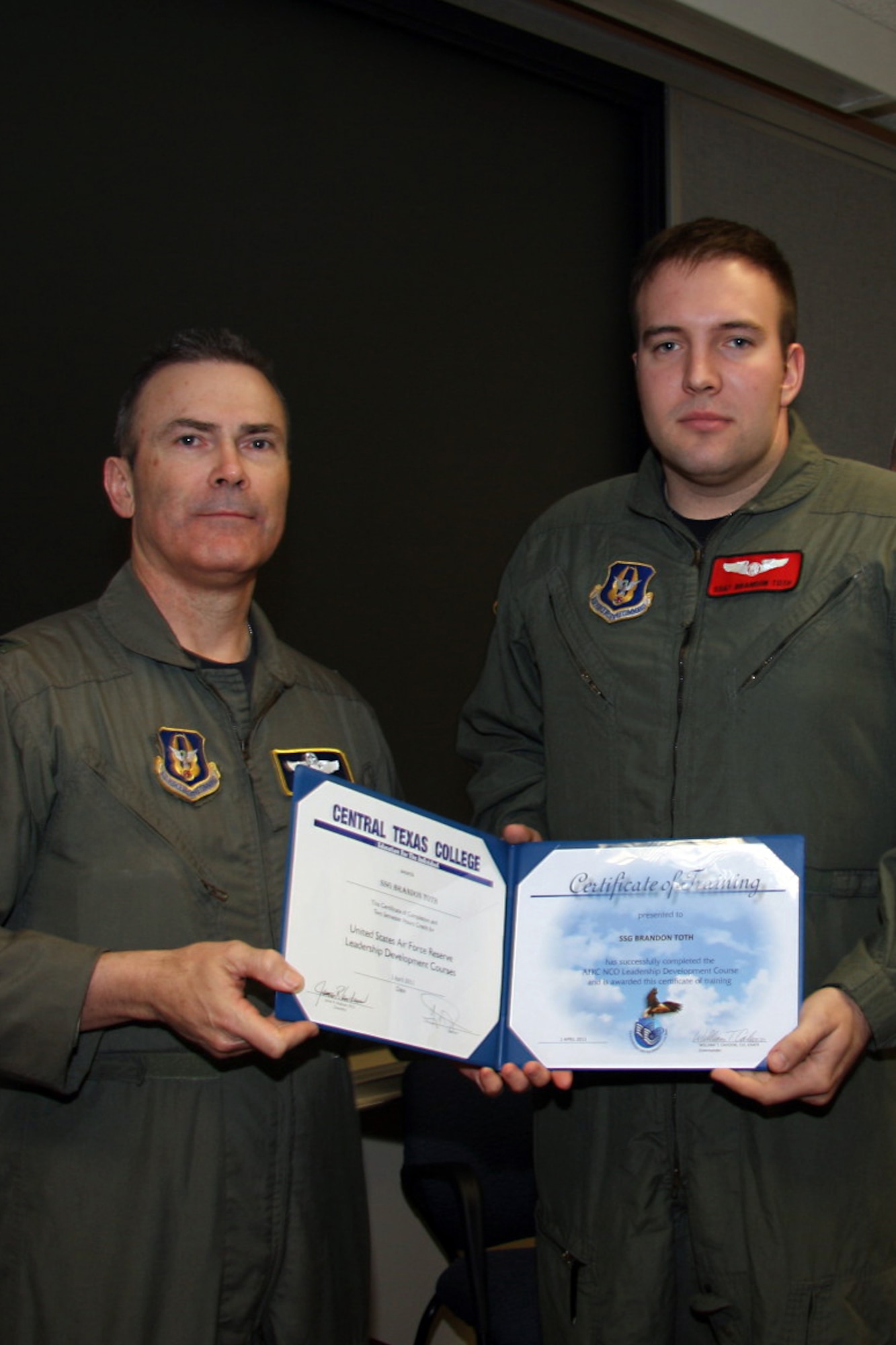 GRISSOM AIR RESERVE BASE, Ind. -- Staff Sgt. Brandon Toth, 74th Air Refueling Squadron inflight refueling journeyman, accepts a noncommissioned officer leadership development course graduation certificate from Col. William T. ?Tim? Cahoon, during a NCOLDC here recently. The 10-day course teaches NCOs how to recognize good leadership practices in an organization, how to recognize the impact of power in a group, and how to develop team-building skills and other leadership qualities. Colonel Cahoon is the 434th Air Refueling Wing commander. (U.S. Air Force photo/Senior Airman Damon Kasberg)