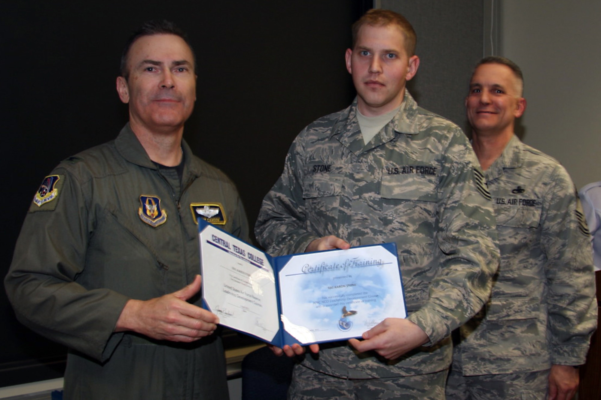 GRISSOM AIR RESERVE BASE, Ind. --Tech. Sgt. Aaron Stone, 434th Logistics Readiness Squadron fuels supply journeyman, is presented with a noncommissioned officer leadership development course graduation certificate by Col. William T. ?Tim? Cahoon and Chief Master Sgt. Kevin Cassidy, during a NCOLDC graduation here recently. The Air Force Reserve Command NCOLDC was established in 1989 in response to a need to provide meaningful and challenging leadership training to mid-level enlisted personnel. Colonel Cahoon is the 434th Air Refueling Wing commander, and Sergeant Cassidy is the 434th Maintenance Squadron maintenance superintendent. (U.S. Air Force photo/Senior Airman Damon Kasberg)