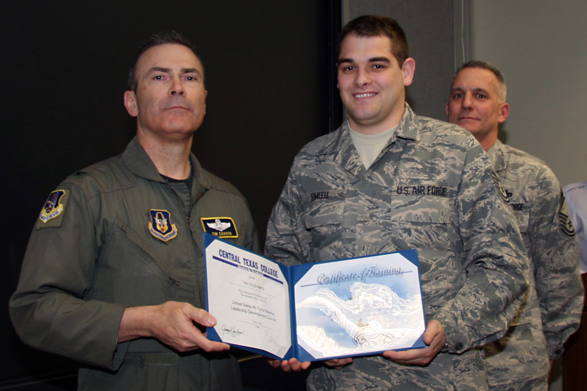 GRISSOM AIR RESERVE BASE, Ind. -- Tech. Sgt. Tyler Smith, 434th Logistics Readiness Squadron fuels supply journeyman, receives a noncommissioned officer leadership development course graduation certificate by Col. William T. ?Tim? Cahoon and Chief Master Sgt. Kevin Cassidy, during a NCOLDC here recently. The 10-day course was established in 1989 in a response to a need to provide meaningful, and challenging leadership training to mid-level enlisted personnel. Colonel Cahoon is the 434th Air Refueling Wing commander, and Sergeant Cassidy is the 434th Maintenance Squadron maintenance superintendent. (U.S. Air Force photo/Senior Airman Damon Kasberg)
