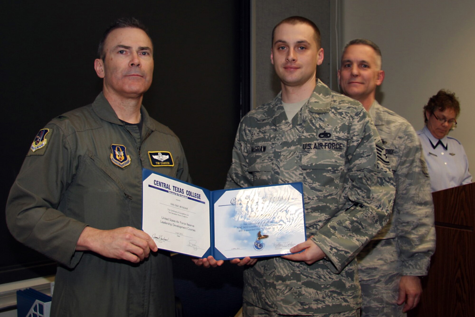 GRISSOM AIR RESERVE BASE, Ind. -- Staff Sgt. Eric McGraw, 434th Aircraft Maintenance Squadron aircraft hydraulic system specialist, accepts a noncommissioned officer leadership development course graduation certificate from Col. William T. ?Tim? Cahoon and Chief Master Sgt. Kevin Cassidy, during a NCOLDC here recently. The 10-day course teaches NCOs how to recognize good leadership practices in an organization, how to recognize the impact of power in a group, and how to develop team-building skills and other leadership qualities. Colonel Cahoon is the 434th Air Refueling Wing commander and Sergeant Cassidy is the 434th Maintenance Squadron maintenance superintendent. (U.S. Air Force photo/Senior Airman Damon Kasberg)
