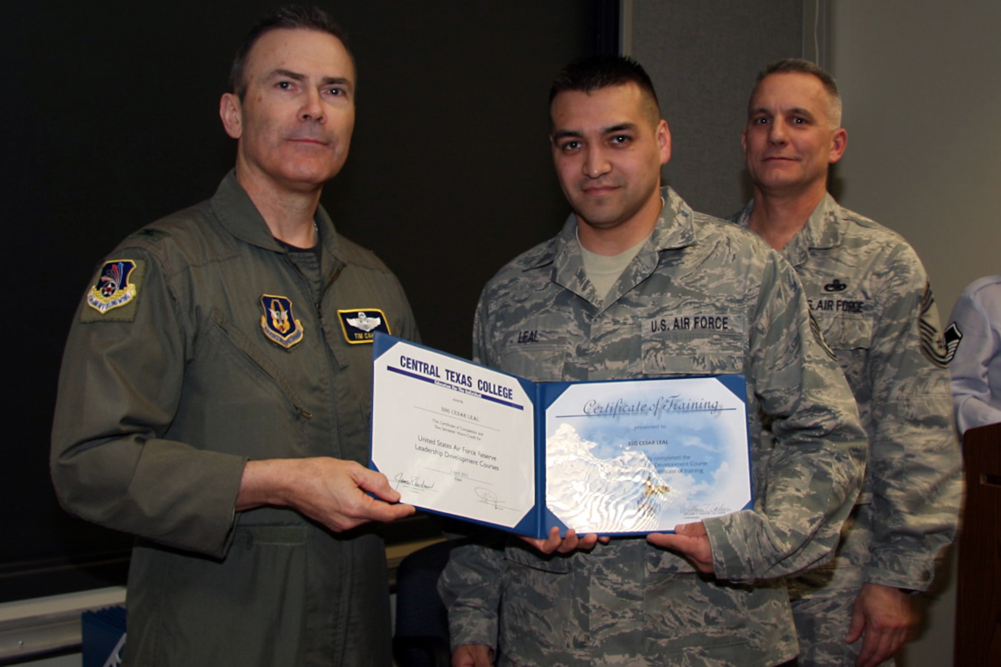 GRISSOM AIR RESERVE BASE, Ind. -- Staff Sgt. Cesar Leal, 434th Aerospace Medicine Squadron dental assistant apprentice, is presented with a noncommissioned officer leadership development course graduation certificate by Col. William T. ?Tim? Cahoon and Chief Master Sgt. Kevin Cassidy, during a NCOLDC graduation here recently. The Air Force Reserve Command NCOLDC was established in 1989 in response to a need to provide meaningful and challenging leadership training to mid-level enlisted personnel. Colonel Cahoon is the 434th Air Refueling Wing commander, and Sergeant Cassidy is the 434th Maintenance Squadron maintenance superintendent. (U.S. Air Force photo/Senior Airman Damon Kasberg)