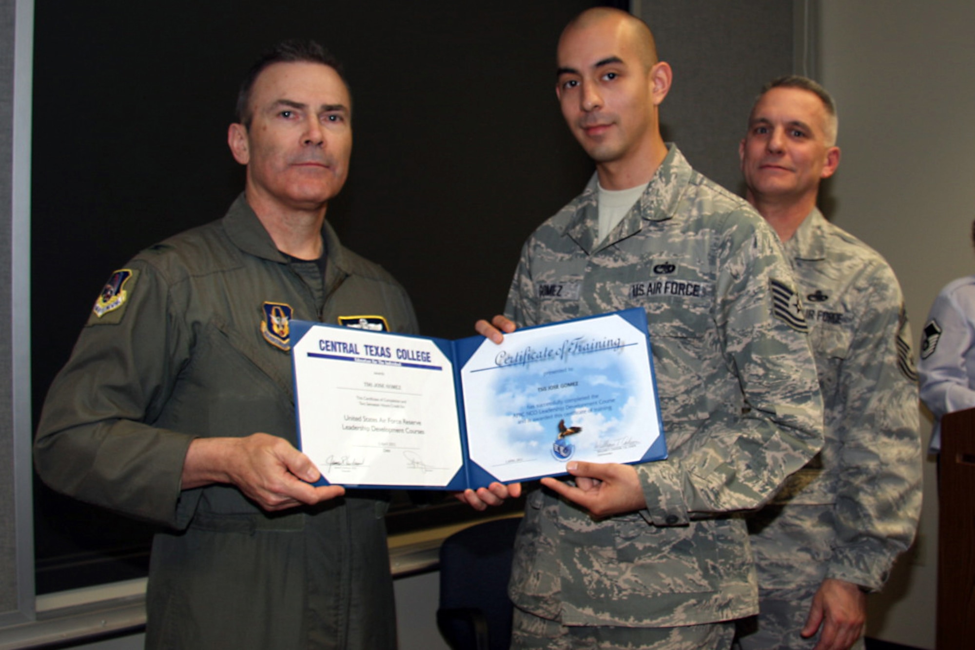 GRISSOM AIR RESERVE BASE, Ind. -- Tech. Sgt. Jose Gomez, Jr., 434th Aircraft Maintenance Squadron KC-135 crew chief, receives a noncommissioned officer leadership development course graduation certificate from Col. William T. ?Tim? Cahoon and Chief Master Sgt. Kevin Cassidy, during a NCOLDC here recently. The 10-day course was established in 1989 in a response to a need to provide meaningful, and challenging leadership training to mid-level enlisted personnel. Colonel Cahoon is the 434th Air Refueling Wing commander, and Sergeant Cassidy is the 434th Maintenance Squadron maintenance superintendent. (U.S. Air Force photo/Senior Airman Damon Kasberg)