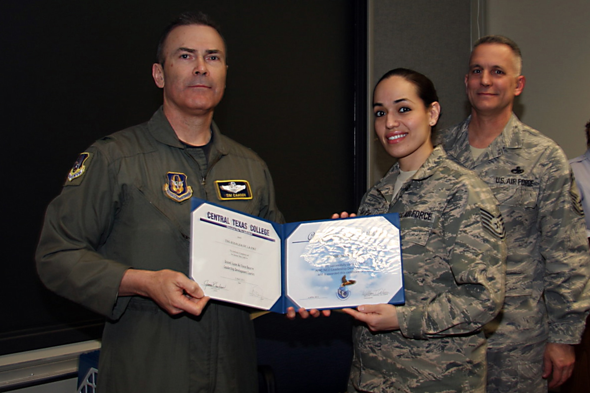 GRISSOM AIR RESERVE BASE, Ind. --Tech. Sgt. Rosalba DeLapaz, 74th Air Refueling Squadron medical element technician, receives a noncommissioned officer leadership development course graduation certificate from Col. William T. ?Tim? Cahoon and Chief Master Sgt. Kevin Cassidy, during a NCOLDC here recently. The 10-day course was established in 1989 in a response to a need to provide meaningful, and challenging leadership training to mid-level enlisted personnel. Colonel Cahoon is the 434th Air Refueling Wing commander, and Sergeant Cassidy is the 434th Maintenance Squadron maintenance superintendent. (U.S. Air Force photo/Senior Airman Damon Kasberg)
