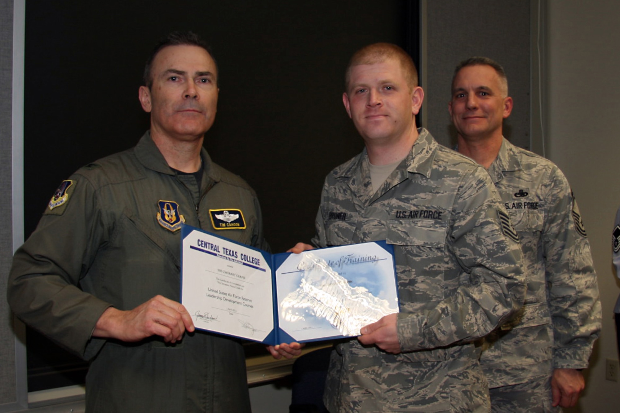 GRISSOM AIR RESERVE BASE, Ind. -- Tech. Sgt. Jeffrey Bruner, 434th Logistics Readiness Squadron fuels supply technician, receives a noncommissioned officer leadership development course graduation certificate from Col. William T. ?Tim? Cahoon and Chief Master Sgt. Kevin Cassidy, during a NCOLDC here recently. The 10-day course was established in 1989 in a response to a need to provide meaningful, and challenging leadership training to mid-level enlisted personnel. Colonel Cahoon is the 434th Air Refueling Wing commander, and Sergeant Cassidy is the 434th Maintenance Squadron maintenance superintendent. (U.S. Air Force photo/Senior Airman Damon Kasberg)