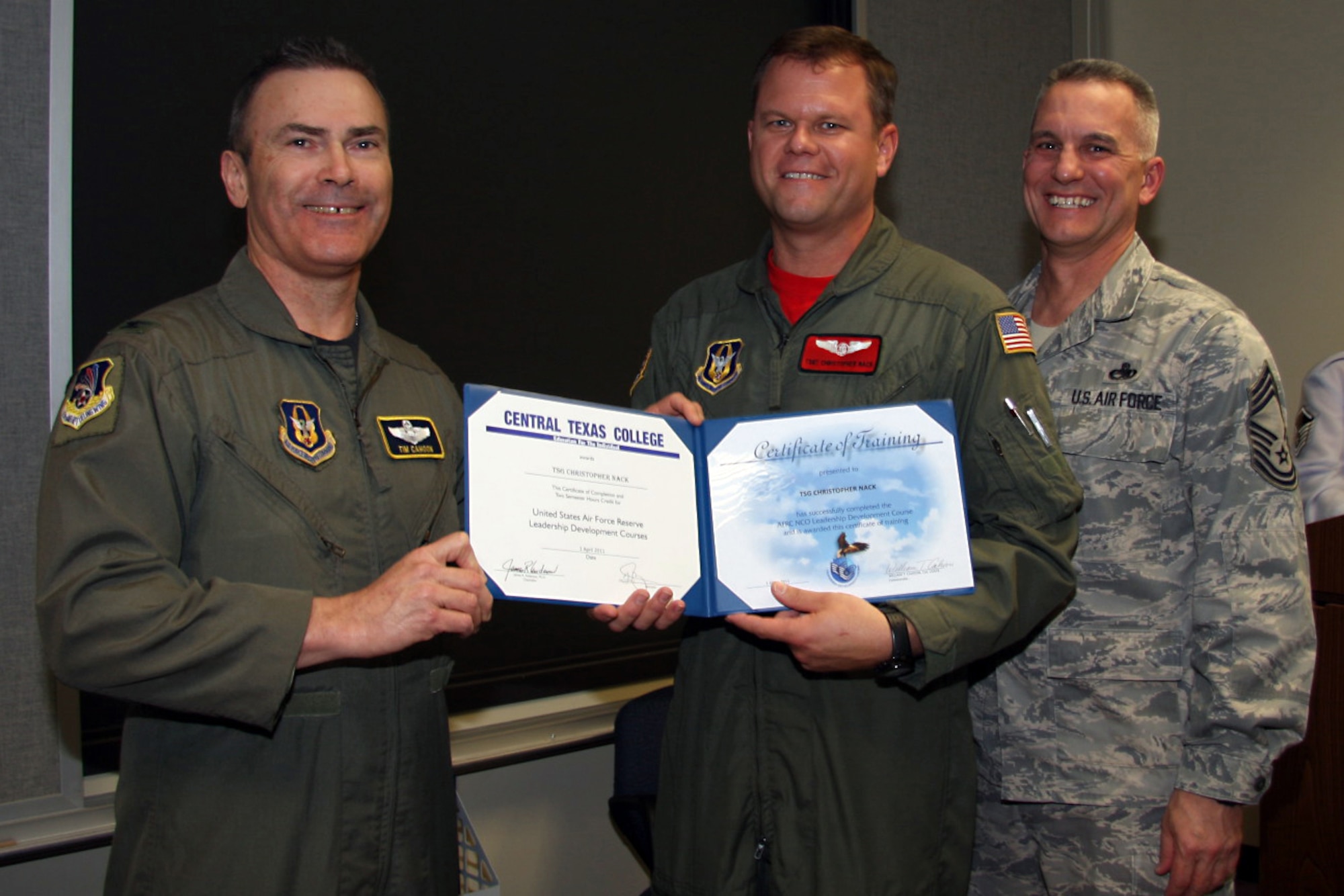 GRISSOM AIR RESERVE BASE, Ind. -- Tech. Sgt. Christopher Nack, 74th Air Refueling Squadron inflight refueling technician, is presented with a noncommissioned officer leadership development course graduation certificate by Col. William T. ?Tim? Cahoon and Chief Master Sgt. Kevin Cassidy, during a NCOLDC graduation here recently. The Air Force Reserve Command NCOLDC was established in 1989 in response to a need to provide meaningful and challenging leadership training to mid-level enlisted personnel. Colonel Cahoon is the 434th Air Refueling Wing commander, and Sergeant Cassidy is the 434th Maintenance Squadron maintenance superintendent. (U.S. Air Force photo/Senior Airman Damon Kasberg)