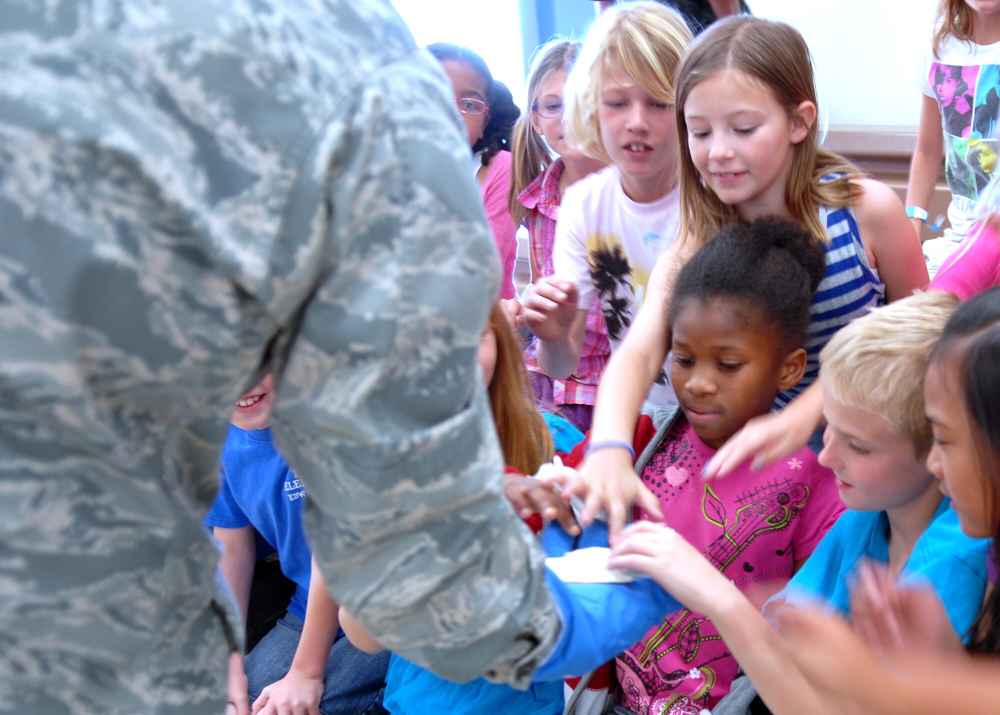 Capt. Jeremy Selstrom, Air Force Research Laboratory Detachment 7 Liquid Engines Branch deputy chief, holds out a banana that had just been submerged in liquid nitrogen, causing it to freeze solid. Captain Selstrom, along with other AFRL personnel, visited Branch Elementary School April 1 to help celebrate the conclusion of the school‘s month-long read-a-thon. (Air Force photo by Kate Blais)