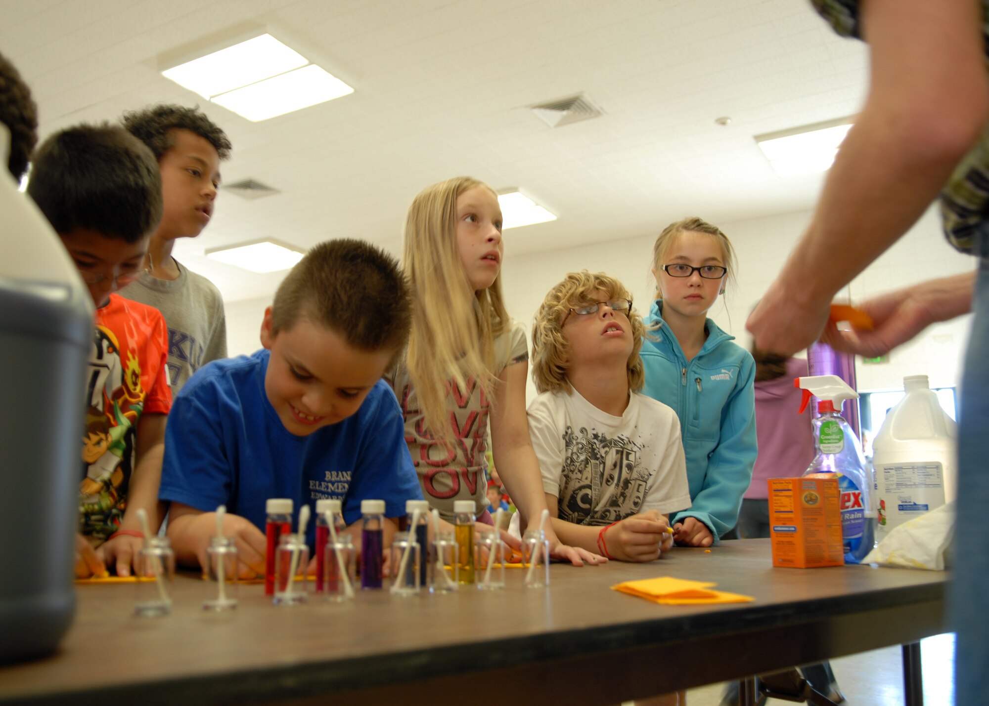 Fourth-graders from Branch Elementary School watch intently as Brian Moore, a chemist at Air Force Research Laboratory Detachment 7, demonstrates how to use pH indicators to differentiate between an acid and a base. Employees from AFRL joined Branch Elementary School students to celebrate the conclusion of the school‘s month long read-a-thon. (Air Force photo by Kate Blais)