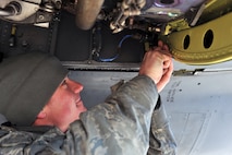 MINOT AIR FORCE BASE, N.D. -- Senior Airman George Querry, 5th Aircraft Maintenance Squadron electrical and environmental specialist, works on the anti-ice system inside the compartment of one of the engines on a B-52H Stratofortress, here April 1. The Airmen of Team Minot perform this kind of maintenance daily to keep Minot AFB’s bomber fleet ready to defend this country’s freedom at a moment’s notice. (U.S. Air Force photo/Staff Sgt. Keith Ballard)  